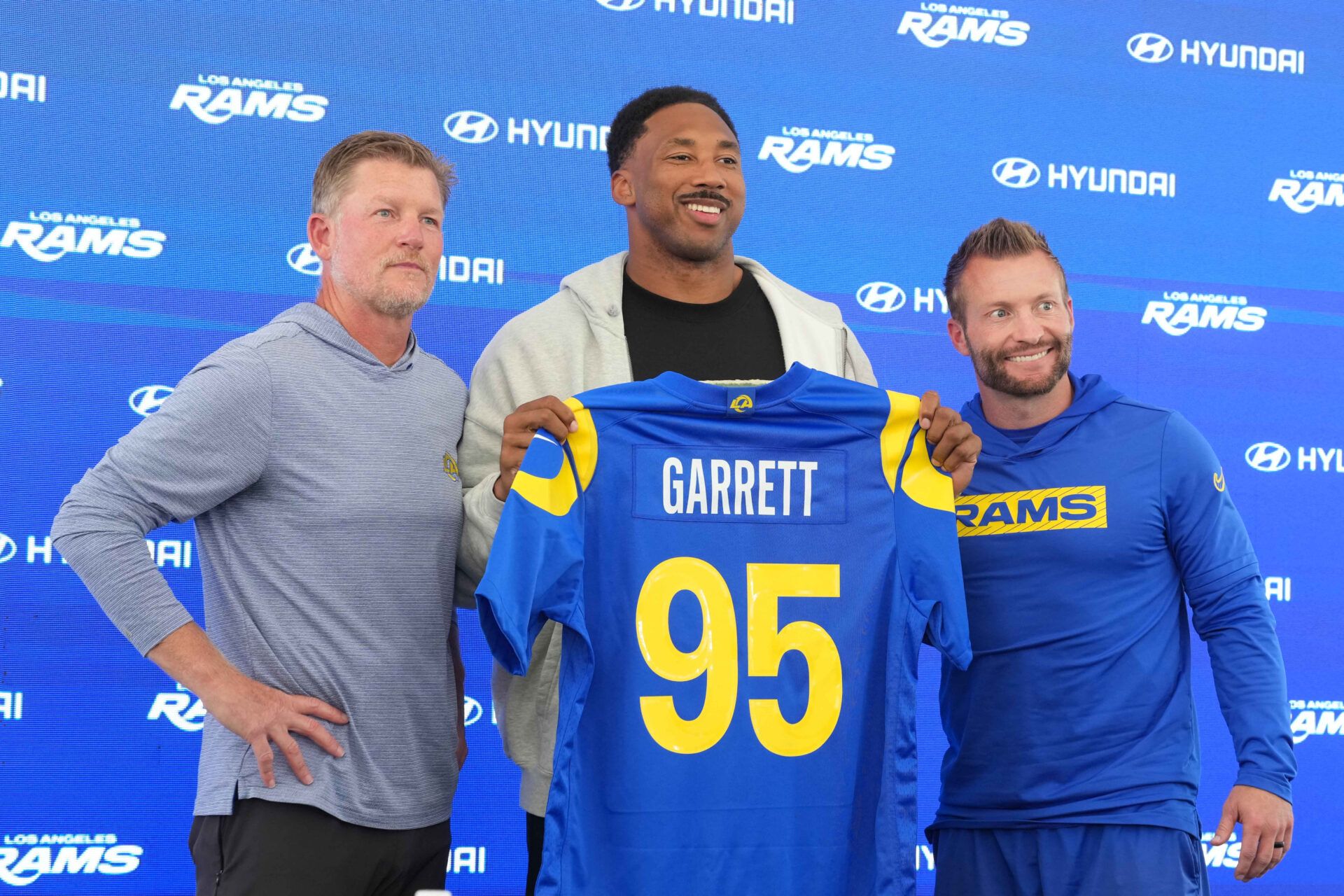 Los Angeles Rams defensive end Myles Garrett (95) poses with general manager Les Snead (left) and coach Sean McVay at press conference at Rams Practice Facility.
