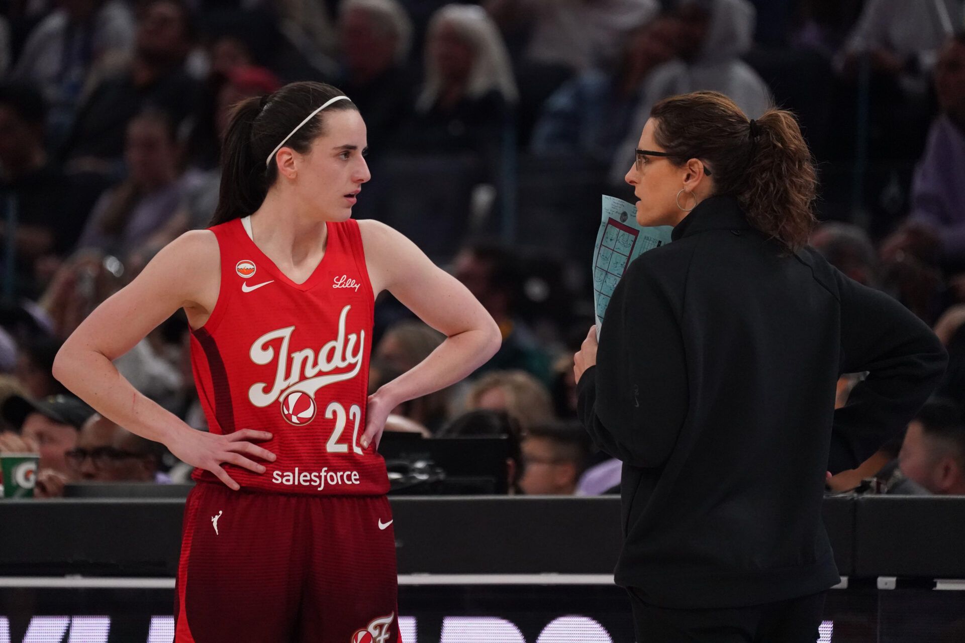 Indiana Fever guard Caitlin Clark (22) talks with head coach Stephanie White during a game against the Golden State Valkyries in the second quarter at Chase Center.