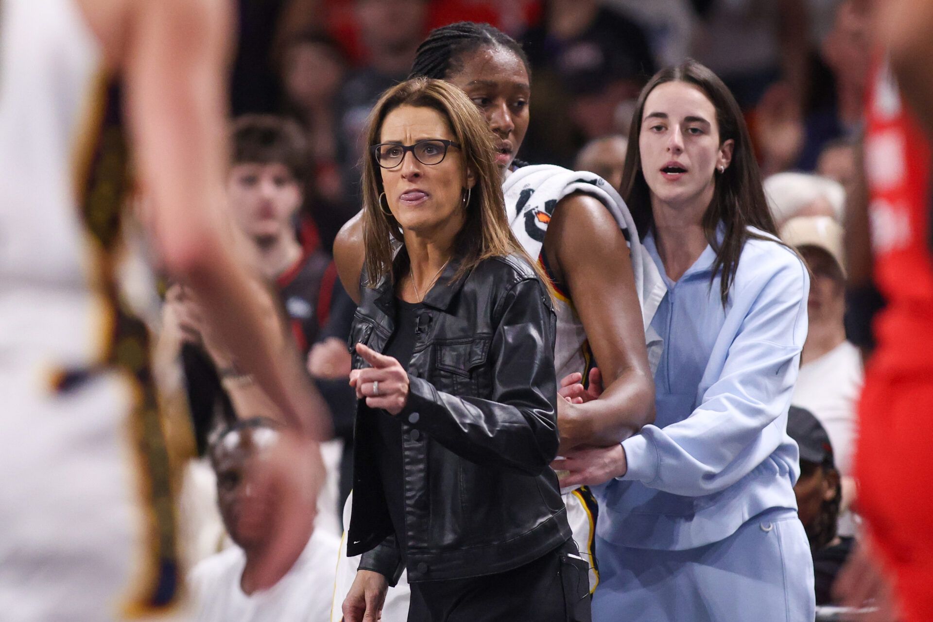 Indiana Fever head coach Stephanie White reacts after being called for a technical foul as forward Aliyah Boston (7) and guard Caitlin Clark (22) stand behind against the Atlanta Dream in the fourth quarter during game one of round one for the 2025 WNBA Playoffs at Gateway Center Arena at College Park.