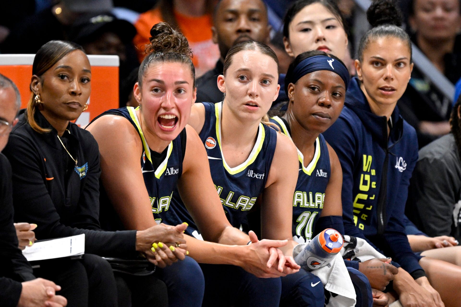 (from left) Dallas Wings forward Jessica Shepard (32) and guard Paige Bueckers (5) and guard Arike Ogunbowale (24) watch the game against the Seattle Storm during the first half at College Park Center.