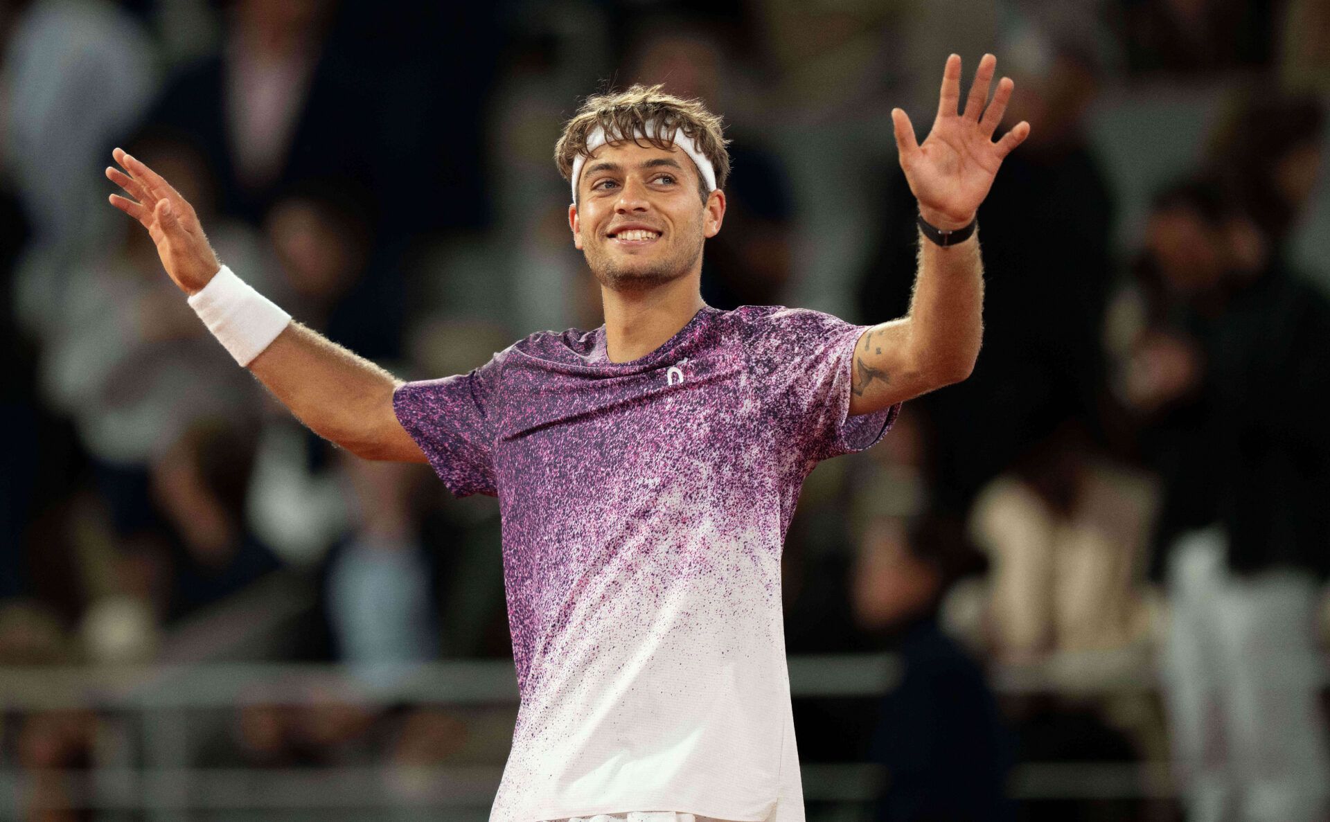 Flavio Cobolli of Italy celebrates winning his match against Felix Auger-Aliassime of Canada on day 11 at Stade Roland Garros.