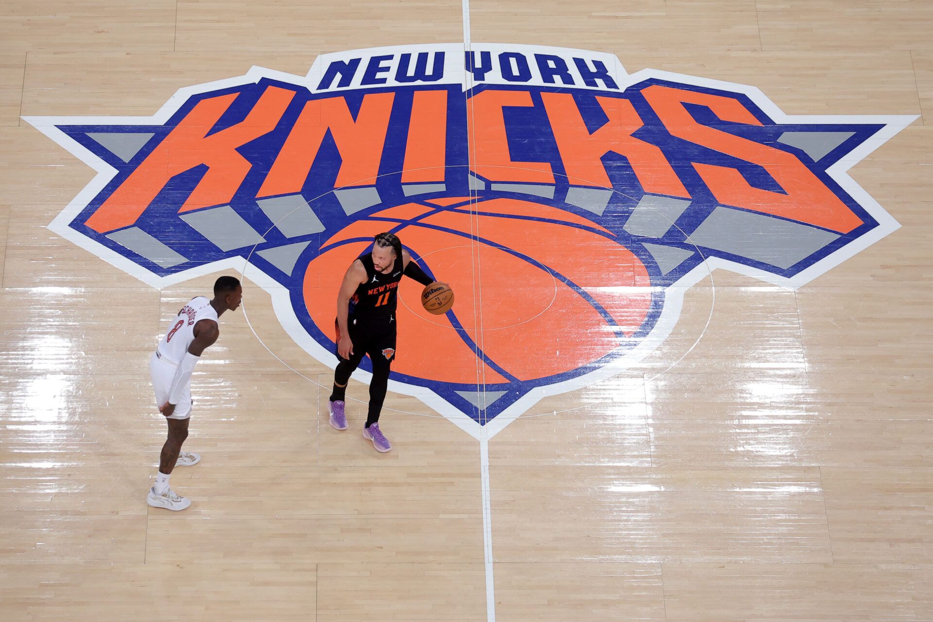New York Knicks guard Jalen Brunson (11) controls the ball against Cleveland Cavaliers guard Dennis Schroder (8) during the third quarter of game two of the eastern conference finals during the 2026 NBA playoffs at Madison Square Garden.
