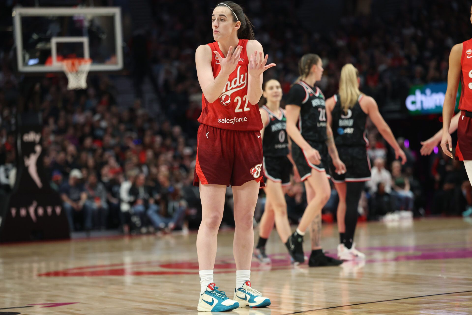 Indiana Fever guard Caitlin Clark (22) chats with a referee during the second half against the Portland Fire at Moda Center.