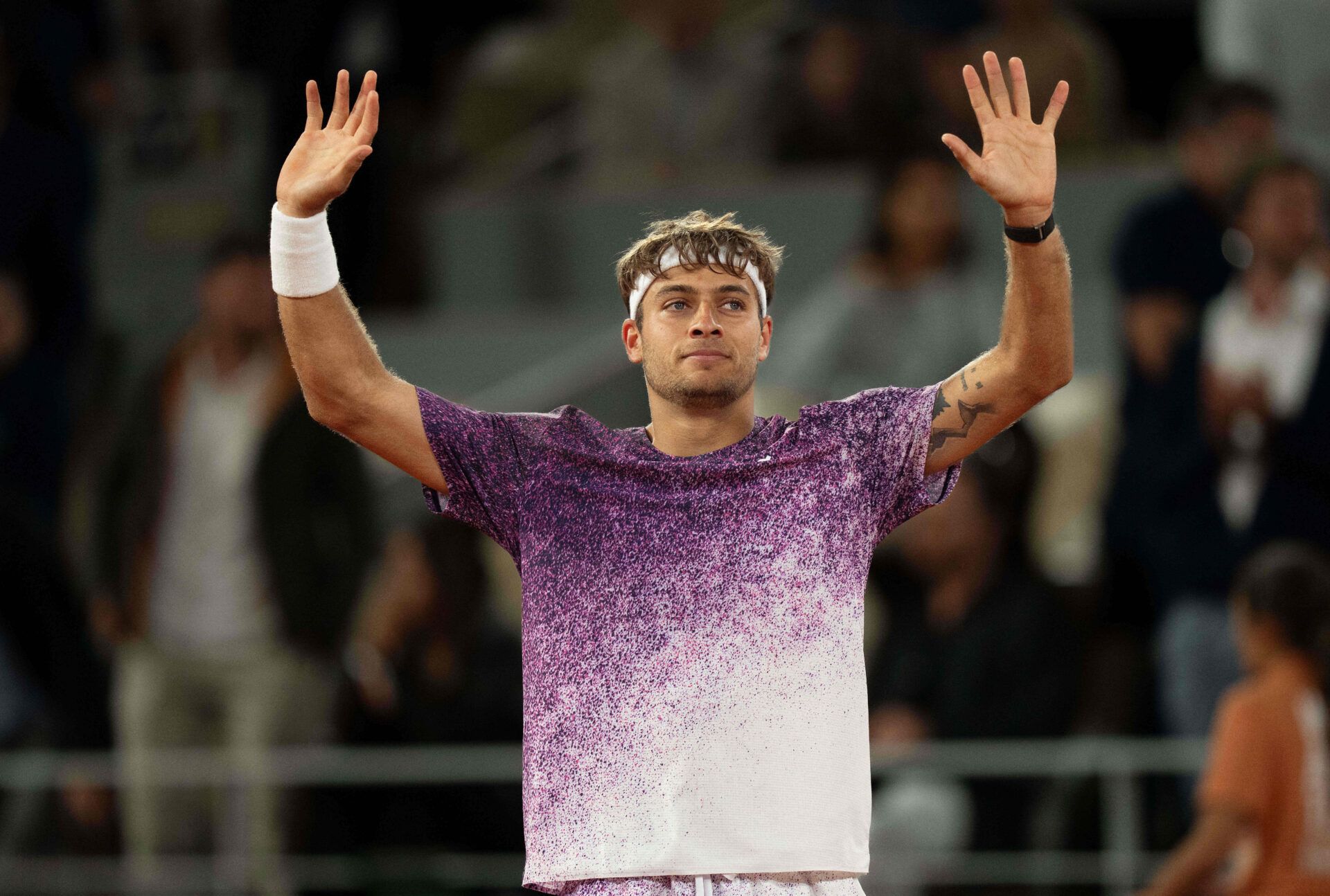 Flavio Cobolli of Italy celebrates winning his match against Felix Auger-Aliassime of Canada on day 11 at Stade Roland Garros.