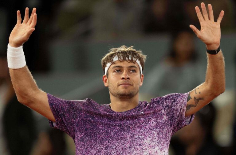 Flavio Cobolli of Italy celebrates winning his match against Felix Auger-Aliassime of Canada on day 11 at Stade Roland Garros.