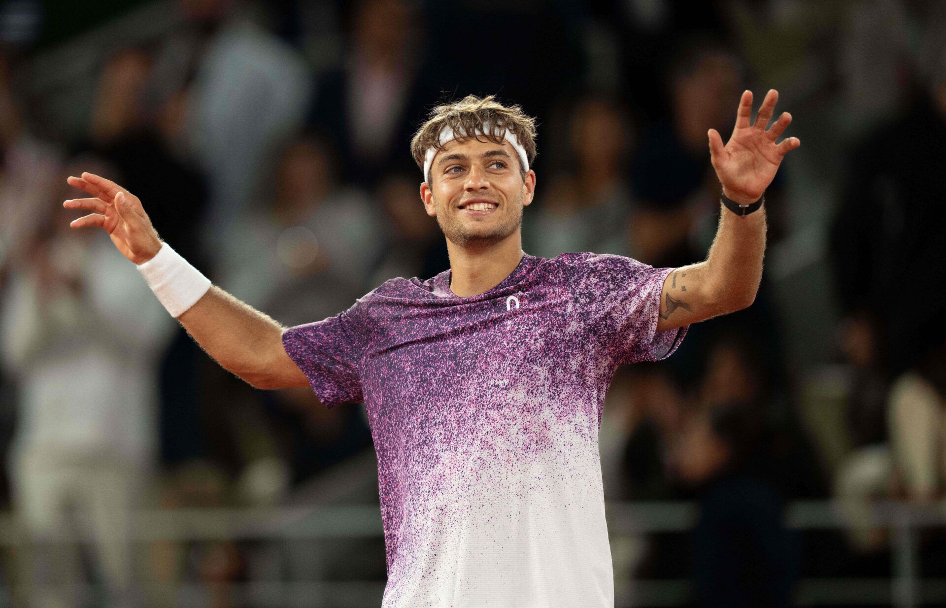 Flavio Cobolli of Italy celebrates winning his match against Felix Auger-Aliassime of Canada on day 11 at Stade Roland Garros.