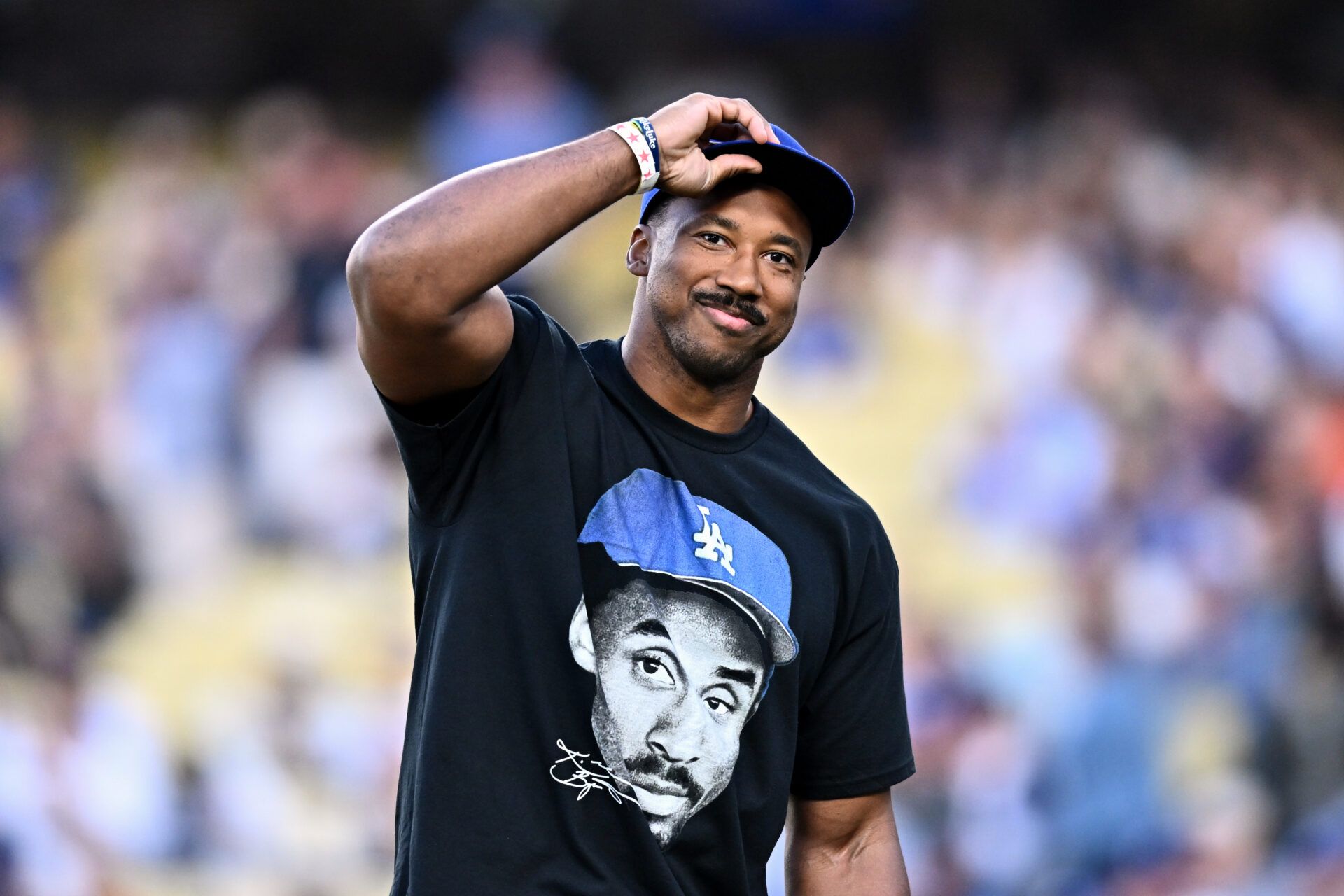 Los Angeles Rams defensive end Myles Garrett looks on prior to throwing out the honorary first pitch before a game between the Los Angeles Angels and Los Angeles Dodgers at Dodger Stadium.
