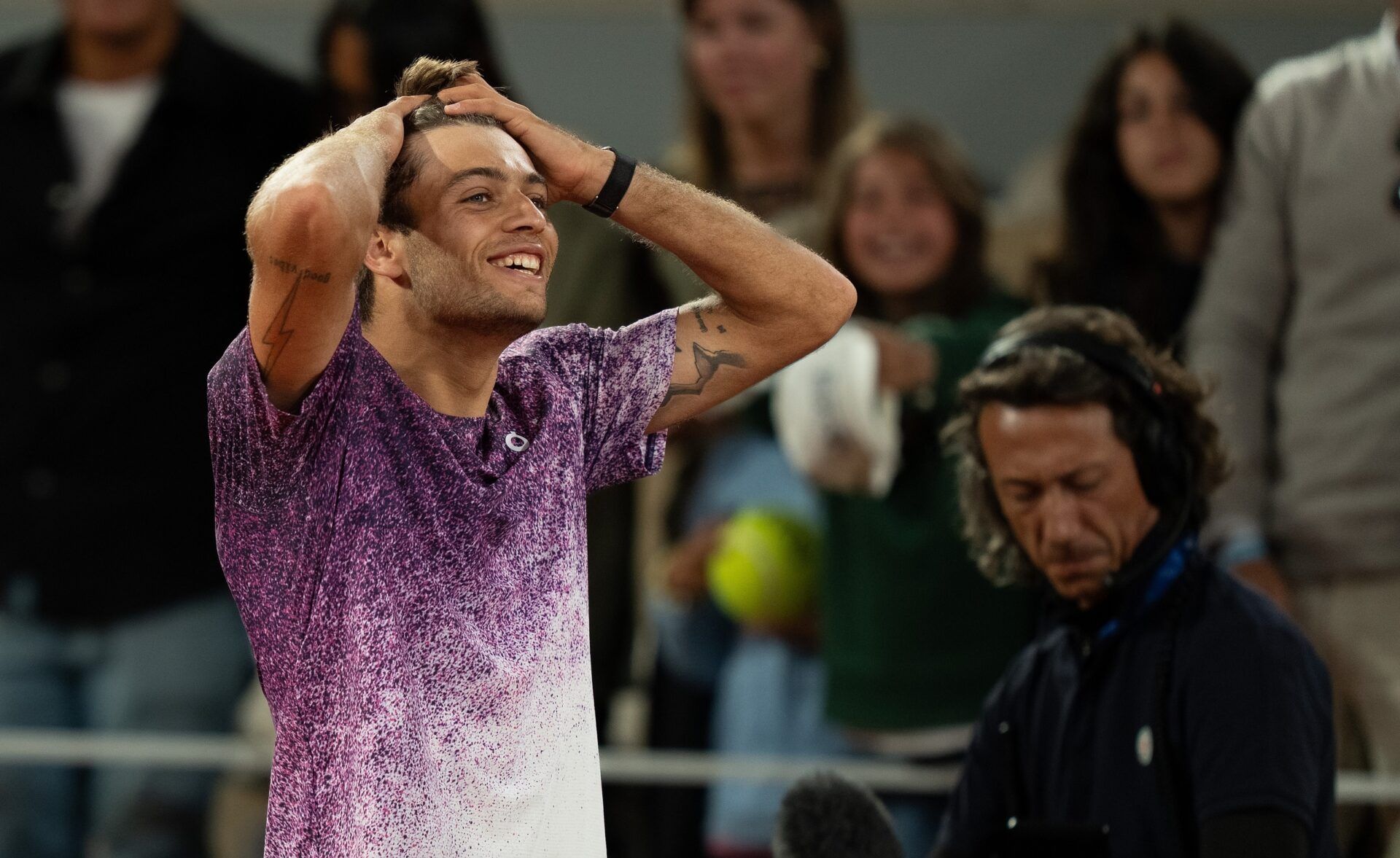 Flavio Cobolli of Italy celebrates winning his match against Felix Auger-Aliassime of Canada on day 11 at Stade Roland Garros.