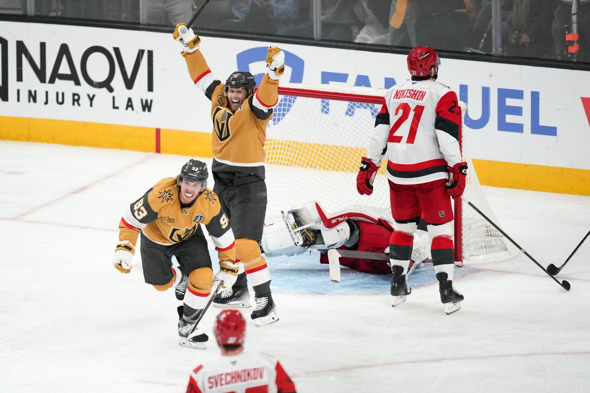 Vegas Golden Knights right wing Mitch Marner (93) and center William Karlsson (71) celebrates a goal by defenseman Shea Theodore (not pictured) against the Carolina Hurricanes during the second overtime in game three of the 2026 Stanley Cup Final at T-Mobile Arena.