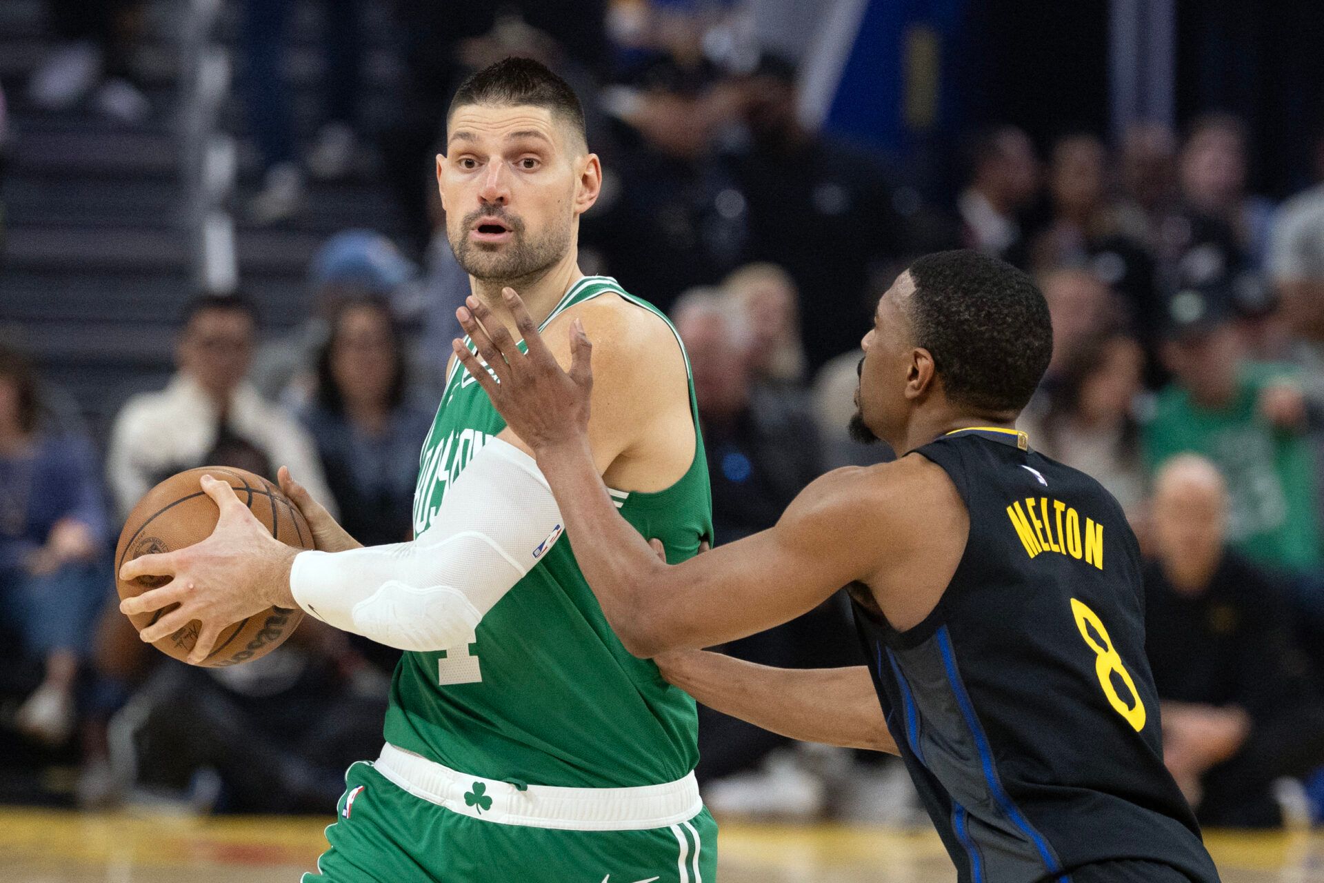 Boston Celtics center Nikola Vucevic (4) looks to pass around Golden State Warriors guard De'Anthony Melton (8) during the first quarter at Chase Center.