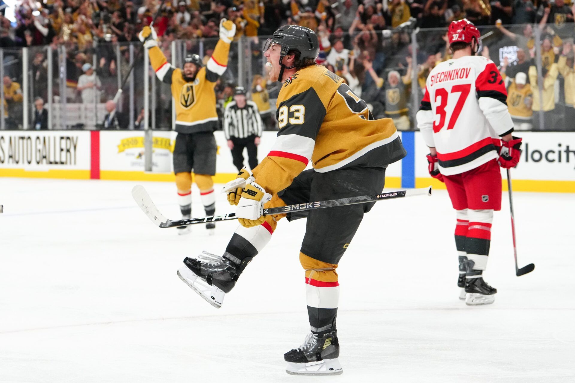 Vegas Golden Knights right wing Mitch Marner (93) celebrates after a goal by defenseman Shea Theodore (not pictured) as Carolina Hurricanes right wing Andrei Svechnikov (37) reacts during the second overtime in game three of the 2026 Stanley Cup Final at T-Mobile Arena.