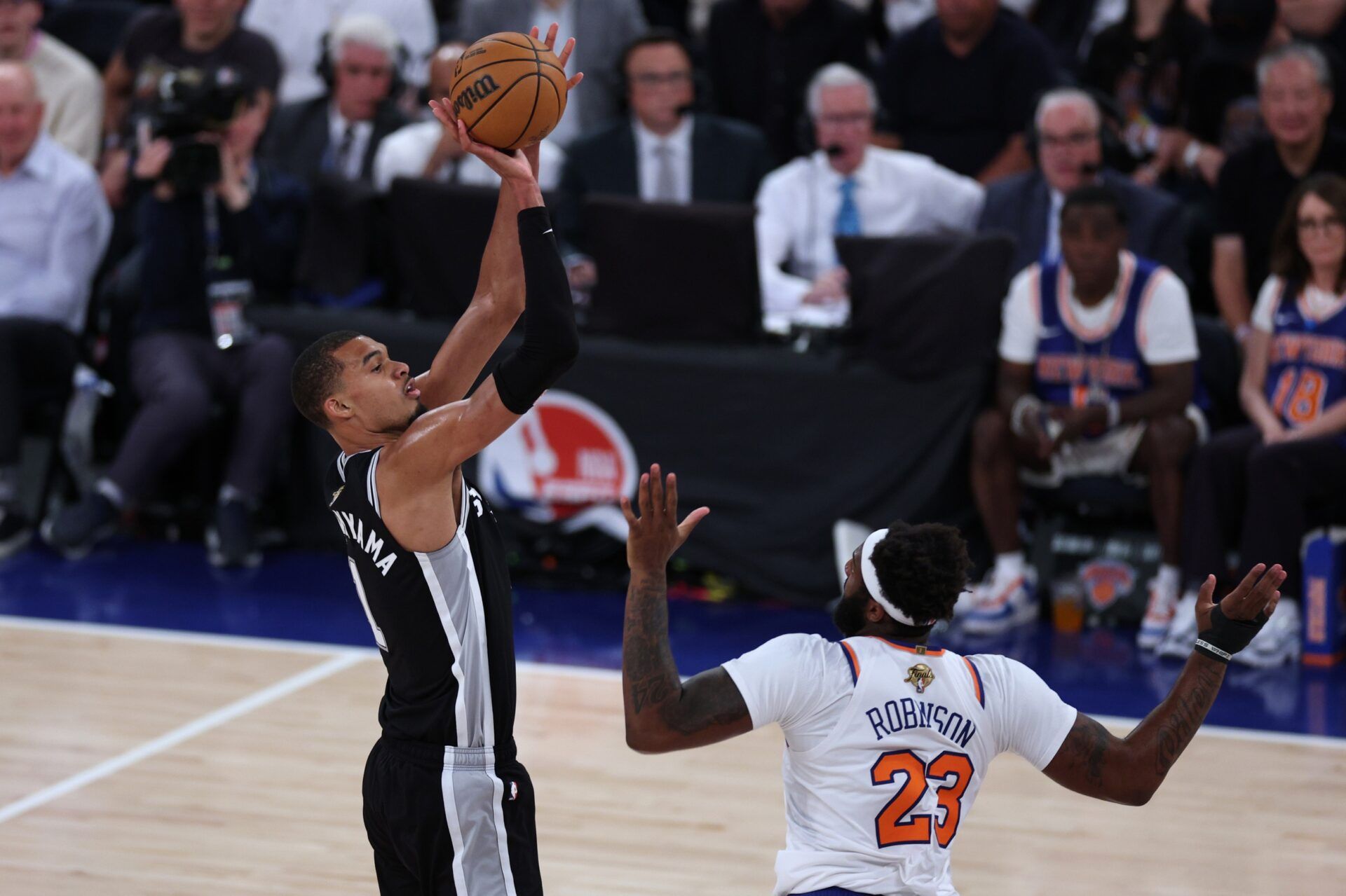 San Antonio Spurs forward Victor Wembanyama (1) shoots against New York Knicks center Mitchell Robinson (23) in the fourth quarter during game three of the 2026 NBA Finals at Madison Square Garden.