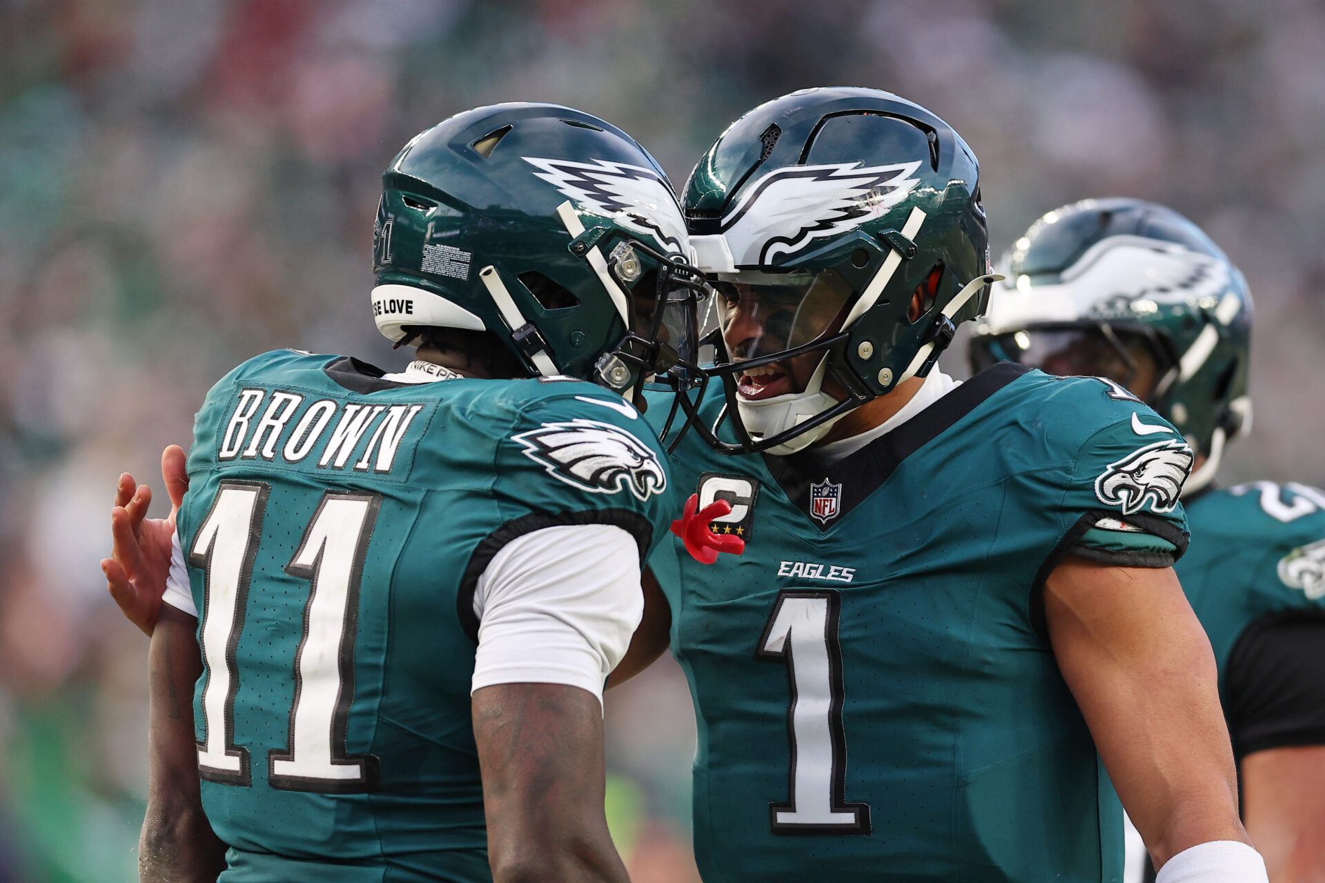 Philadelphia Eagles quarterback Jalen Hurts (1) and wide receiver A.J. Brown (11) celebrate after a touchdown against the Washington Commanders during the first half in the NFC Championship game at Lincoln Financial Field.