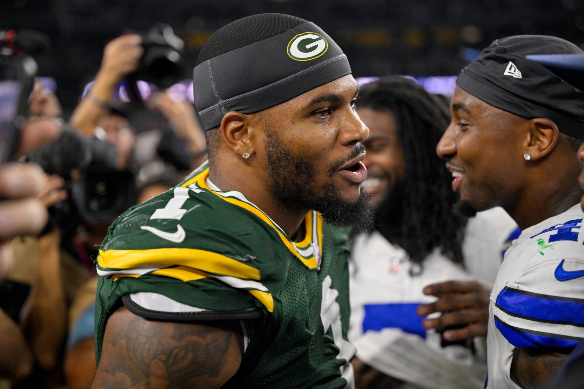 Green Bay Packers defensive end Micah Parsons (1) talks with his former teammates after the game between the Dallas Cowboys and the Green Bay Packers at AT&T Stadium.