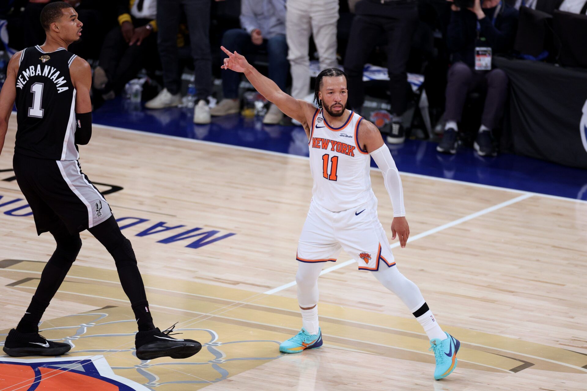 New York Knicks guard Jalen Brunson (11) reacts as San Antonio Spurs forward Victor Wembanyama (1) looks on in the second quarter during game three of the 2026 NBA Finals at Madison Square Garden.