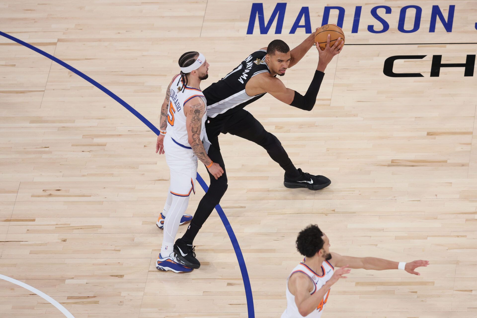San Antonio Spurs forward Victor Wembanyama (1) controls the ball against New York Knicks guard Jose Alvarado (5) during game three of the 2026 NBA Finals in the fourth quarter at Madison Square Garden.