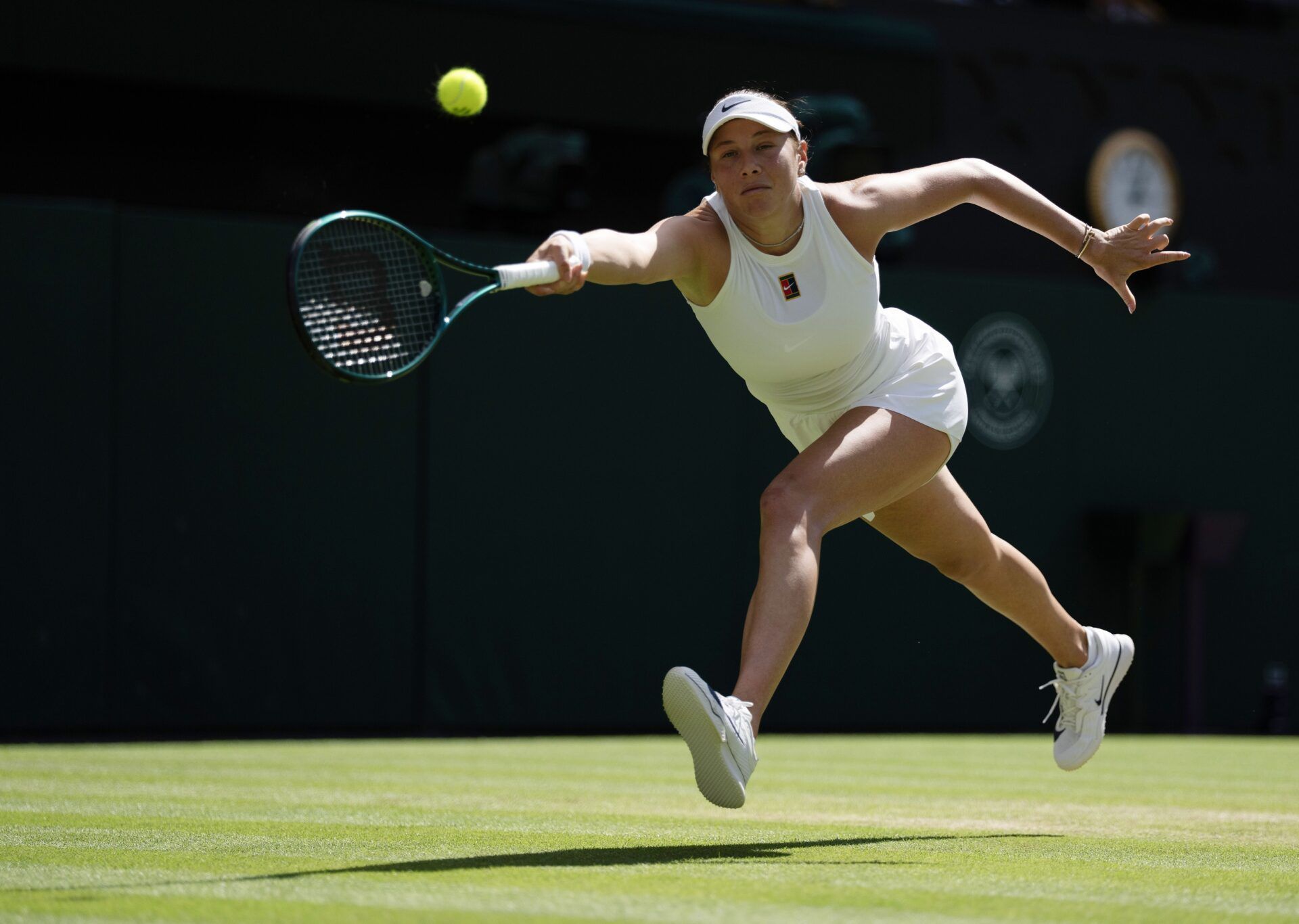 Amanda Anisimova of the United States returns a shot during her match against Aryna Sabalenka on day 11 at All England Lawn Tennis and Croquet Club.