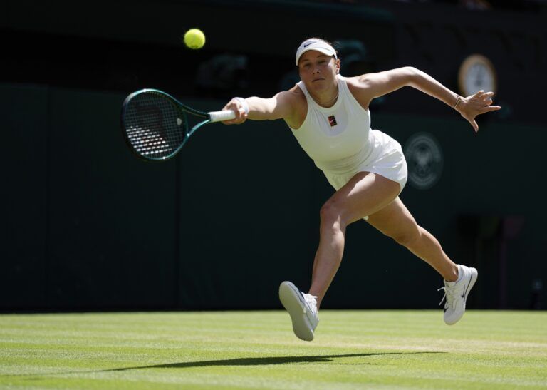 Amanda Anisimova of the United States returns a shot during her match against Aryna Sabalenka on day 11 at All England Lawn Tennis and Croquet Club.