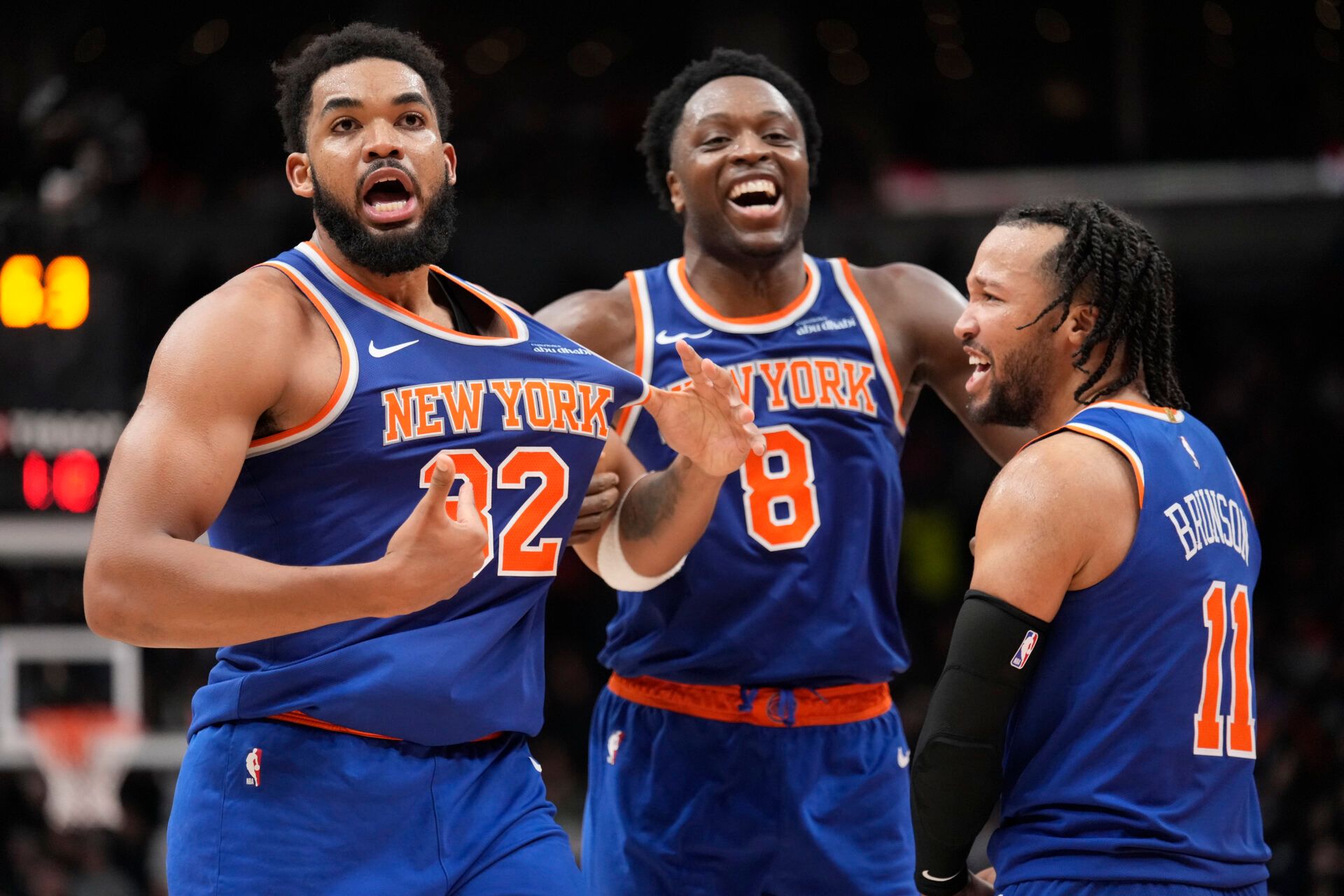 New York  Knicks guard Jalen Brunson (11) and forward OG Anunoby (8) react after a three point basket by center Karl-Anthony Towns (32) to clinch a win over the Toronto Raptors during the second half at Scotiabank Arena.
