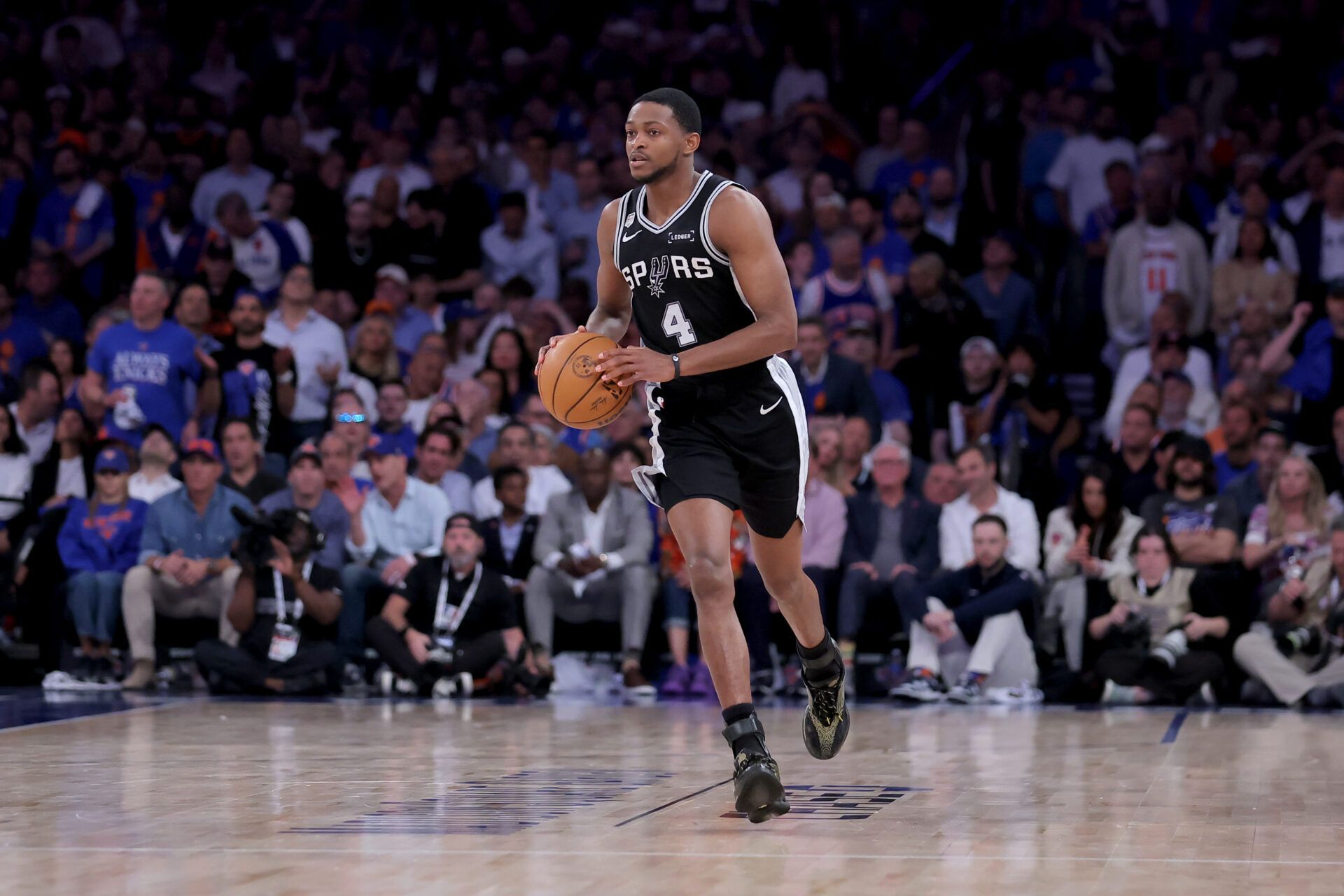 San Antonio Spurs guard De'aaron Fox (4) brings the ball up court against the New York Knicks during the fourth quarter of game four of the 2026 NBA Finals at Madison Square Garden.