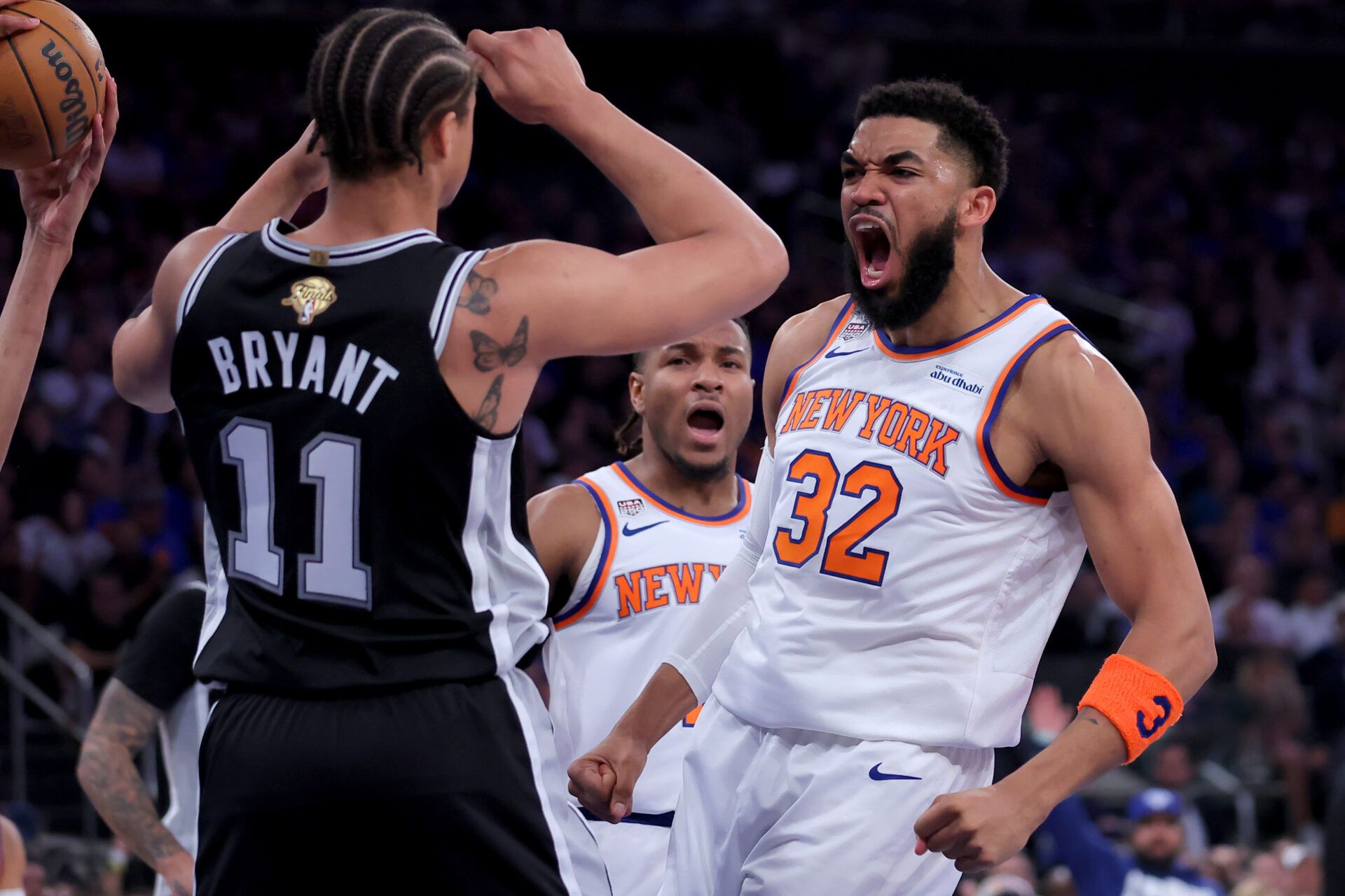 New York Knicks center Karl-Anthony Towns (32) reacts against San Antonio Spurs forward Carter Bryant (11) during the second quarter of game four of the 2026 NBA Finals at Madison Square Garden.