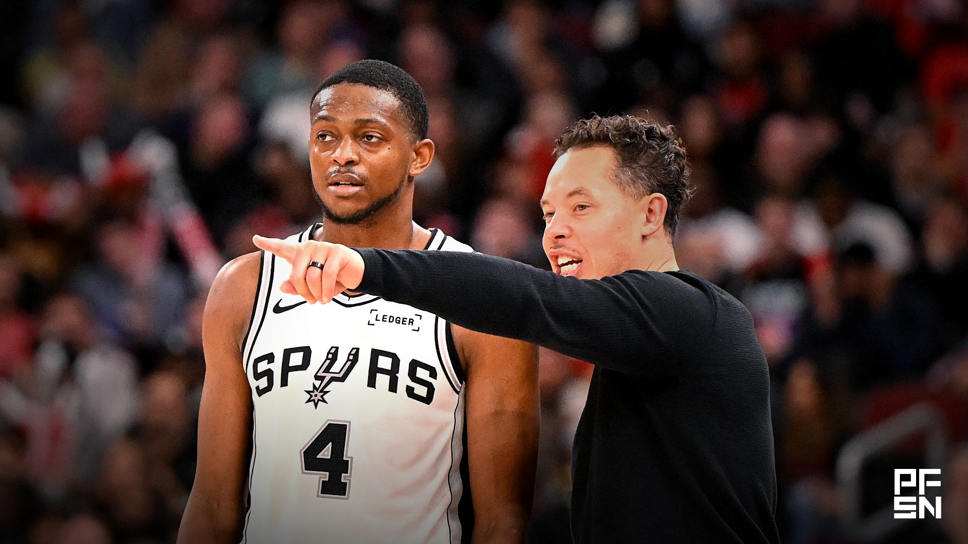San Antonio Spurs head coach Mitch Johnson talks with guard De'Aaron Fox (4) during the second half against the Chicago Bulls at the United Center.
