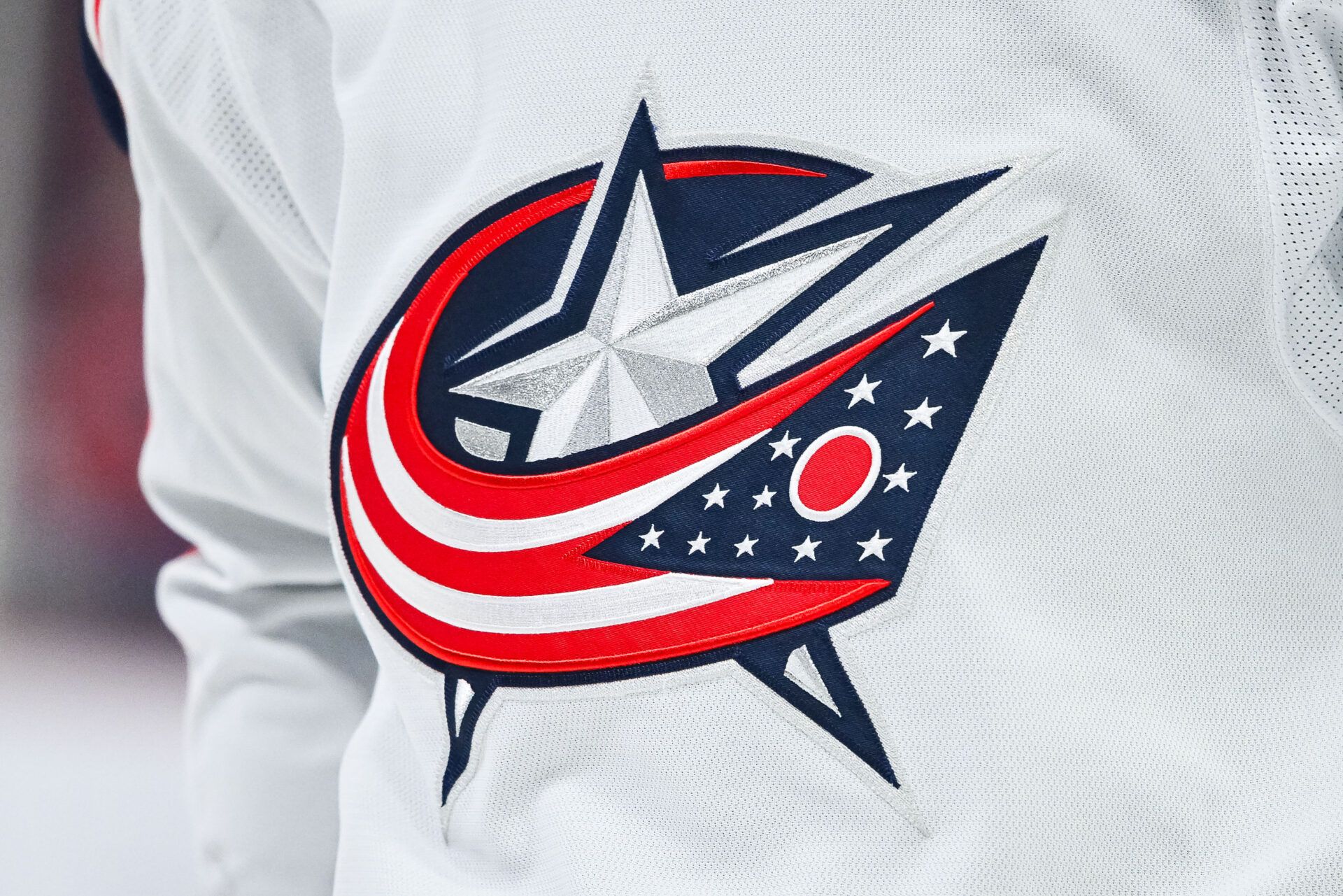 View of a Columbus Blue Jackets logo on a jersey worn by a member of the team during warm-up before the game against the Montreal Canadiens at Bell Centre.