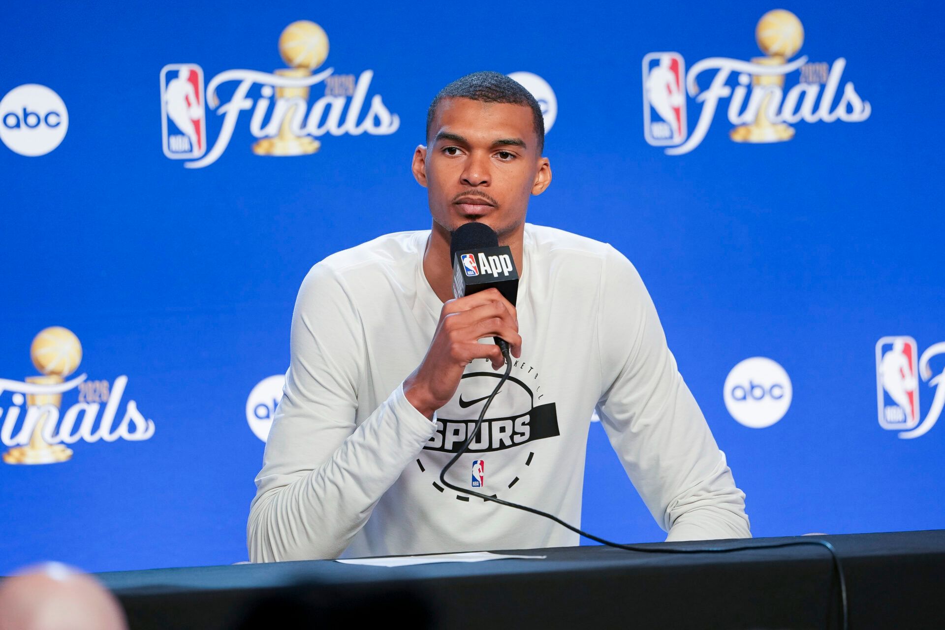 San Antonio Spurs forward Victor Wembanyama (1) speaks with the media after the game between the Spurs and the Knicks in game two of the 2026 NBA Finals at Frost Bank Center.