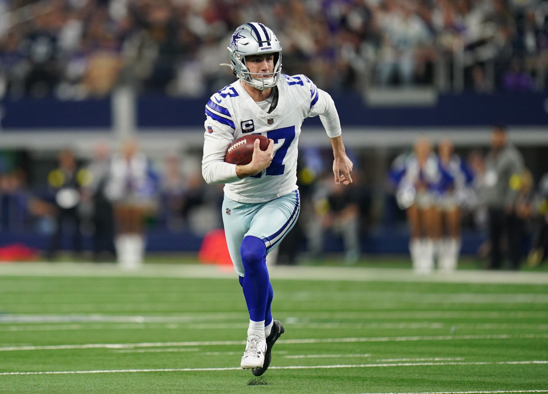 Dallas Cowboys place kicker Brandon Aubrey (17) runs a fake field goal during the first half against the Minnesota Vikings at AT&T Stadium.