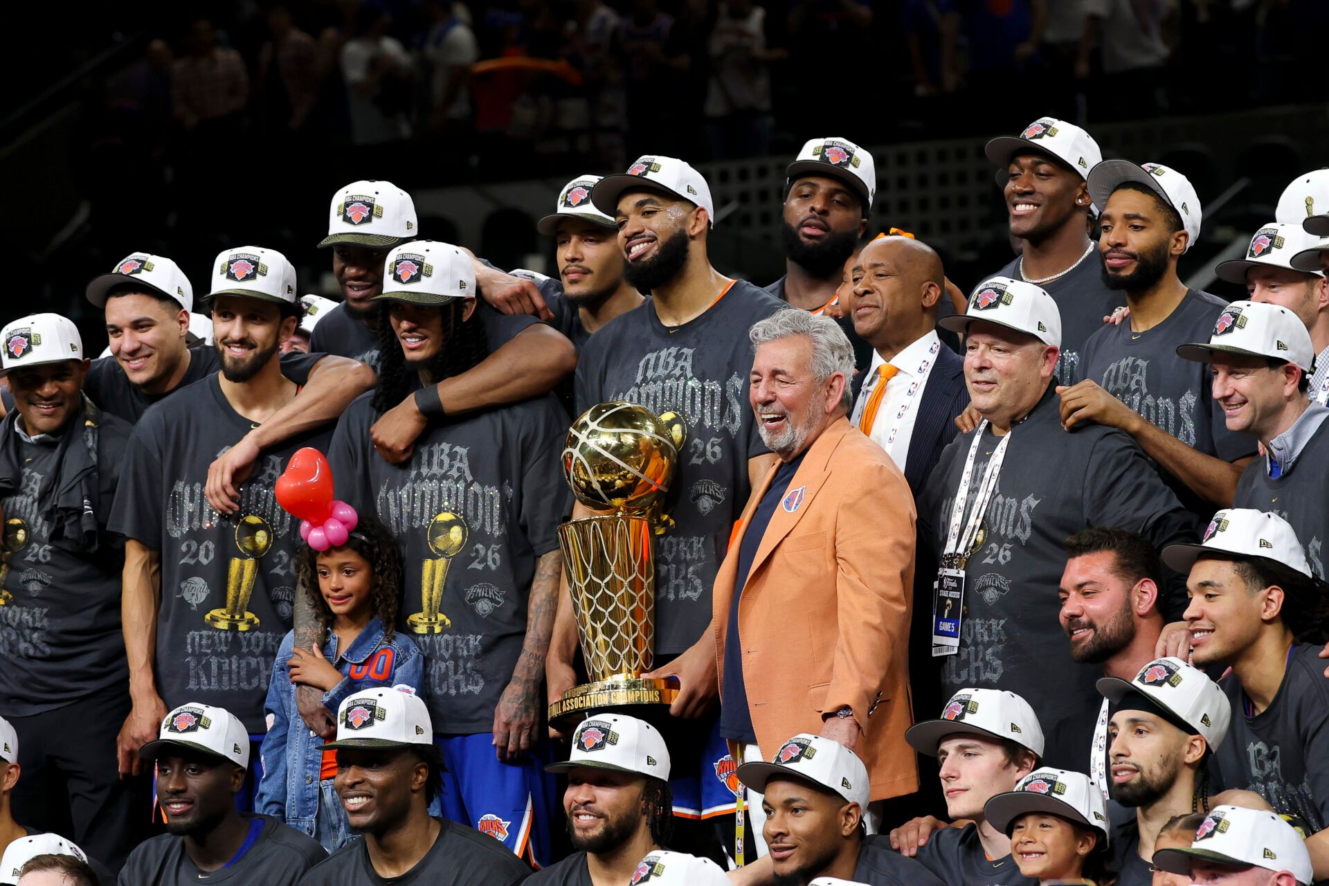 New York Knicks owner James Dolan and the Knicks pose with the trophy after the Knicks defeat the San Antonio Spurs during game five of the 2026 NBA Finals at Frost Bank Center.
