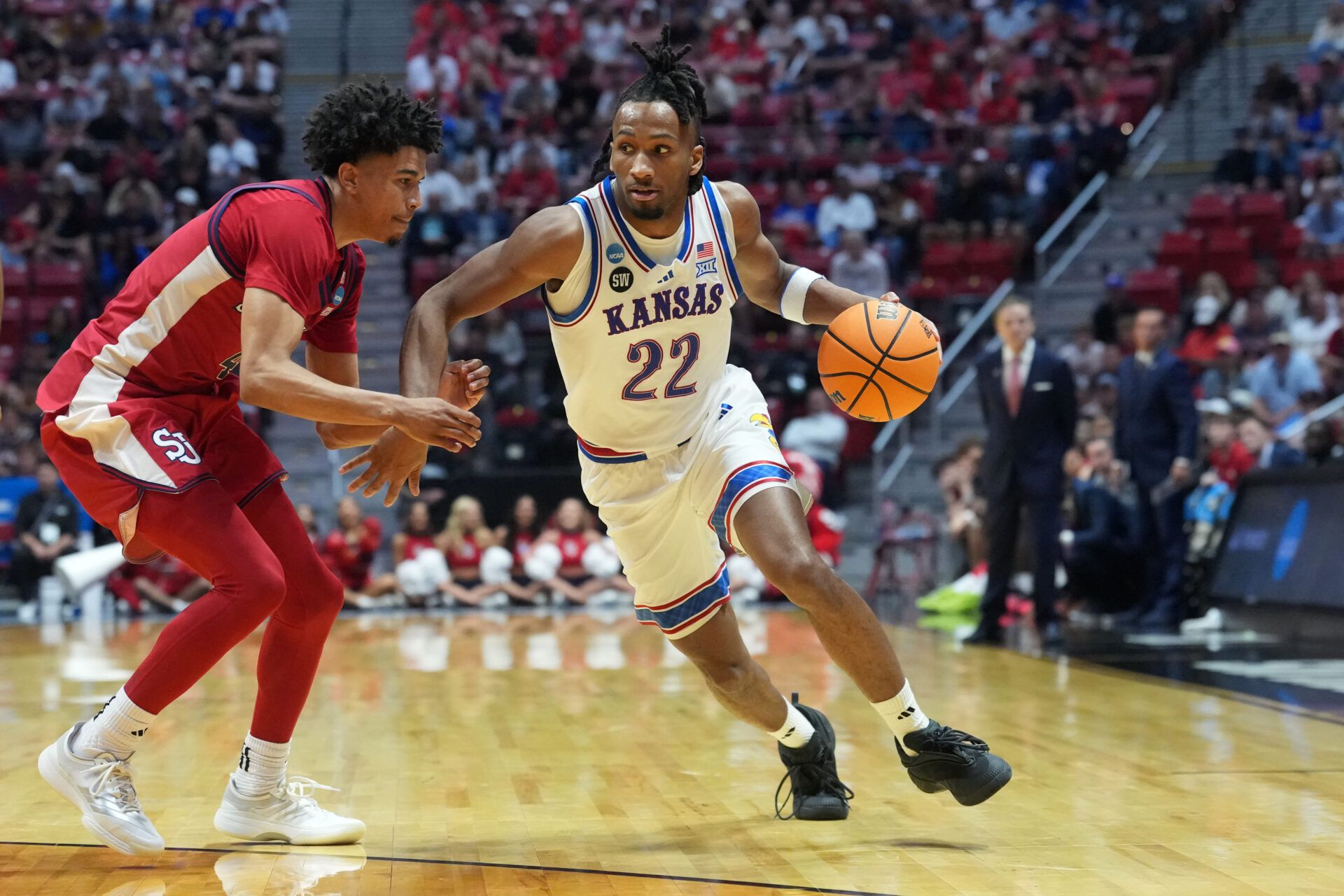 Kansas Jayhawks guard Darryn Peterson (22) controls the ball against St. John's Red Storm guard Oziyah Sellers (4) in the second half during a second round game of the men's 2026 NCAA Tournament at Viejas Arena.