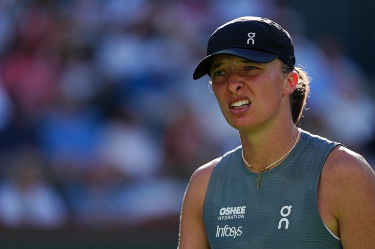 Iga Swiatek looks towards her coach during a BNP Paribas Open quarterfinal match in Indian Wells, Calif., on Thursday, March 12, 2026.