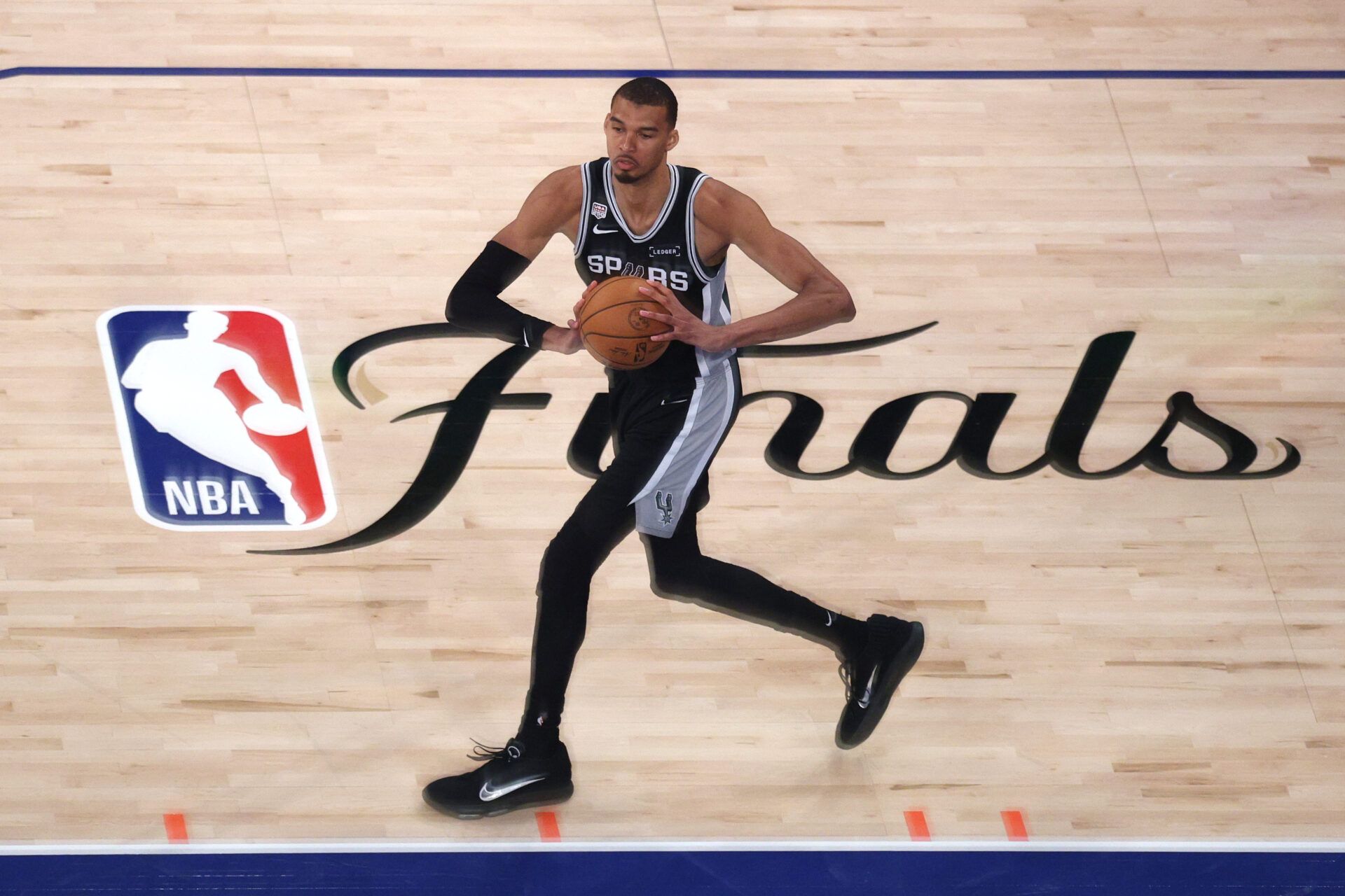 San Antonio Spurs forward Victor Wembanyama (1) passes the ball against the New York Knicks during game four of the 2026 NBA Finals in the third quarter at Madison Square Garden.