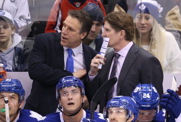 Toronto Maple Leafs head coach Mike Babcock listens to assistant coach Jim Hiller against the Washington Capitals at Air Canada Centre. The Capitals beat the Maple Leafs 4-2.