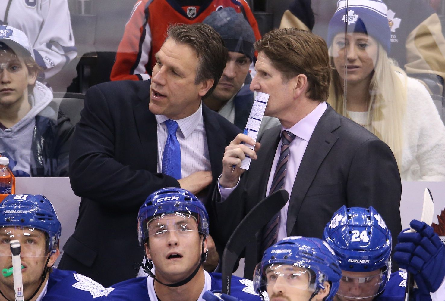 Toronto Maple Leafs head coach Mike Babcock listens to assistant coach Jim Hiller against the Washington Capitals at Air Canada Centre. The Capitals beat the Maple Leafs 4-2.