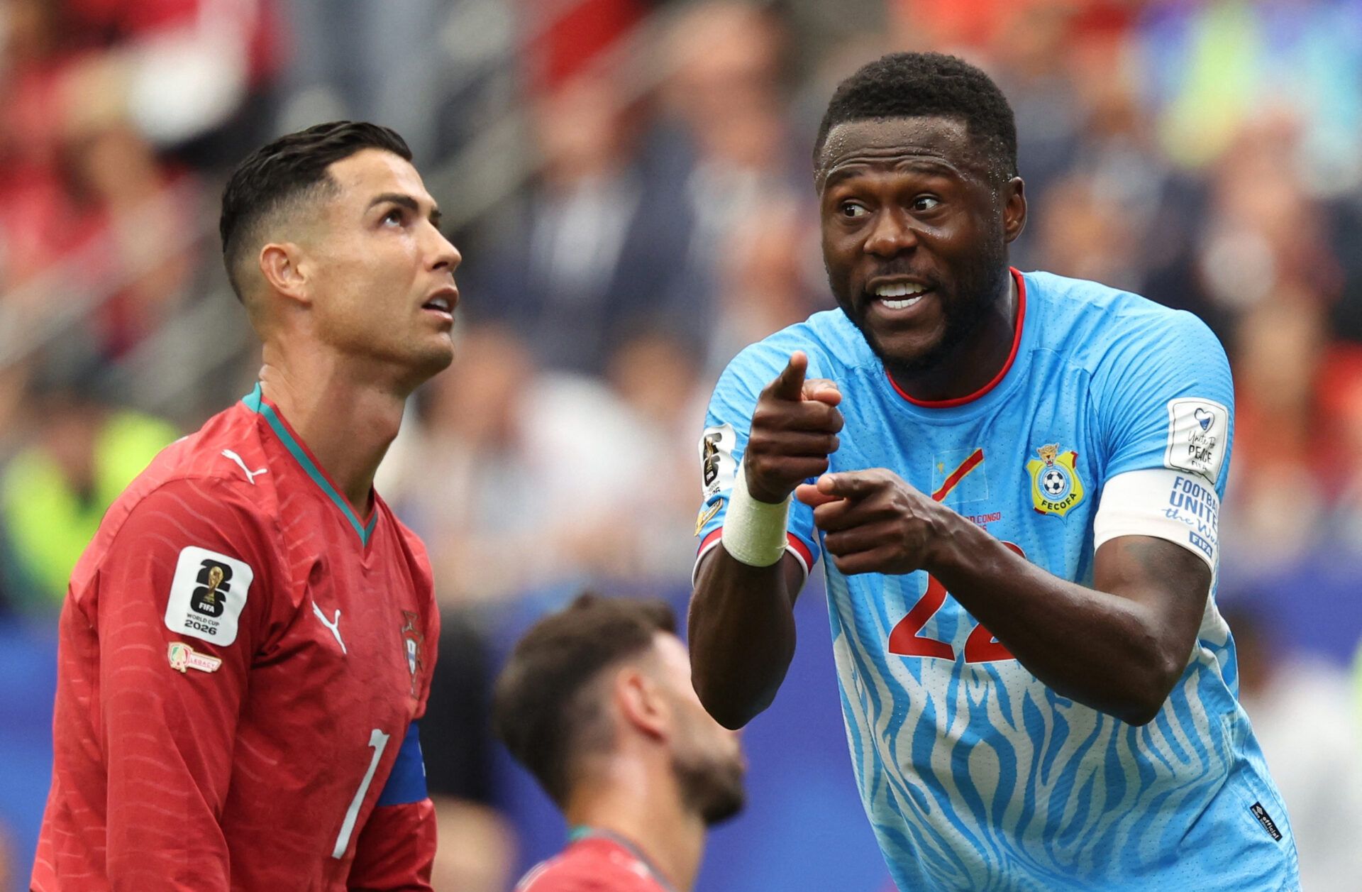 Portugal's Cristiano Ronaldo and DR Congo's Chancel Mbemba react.