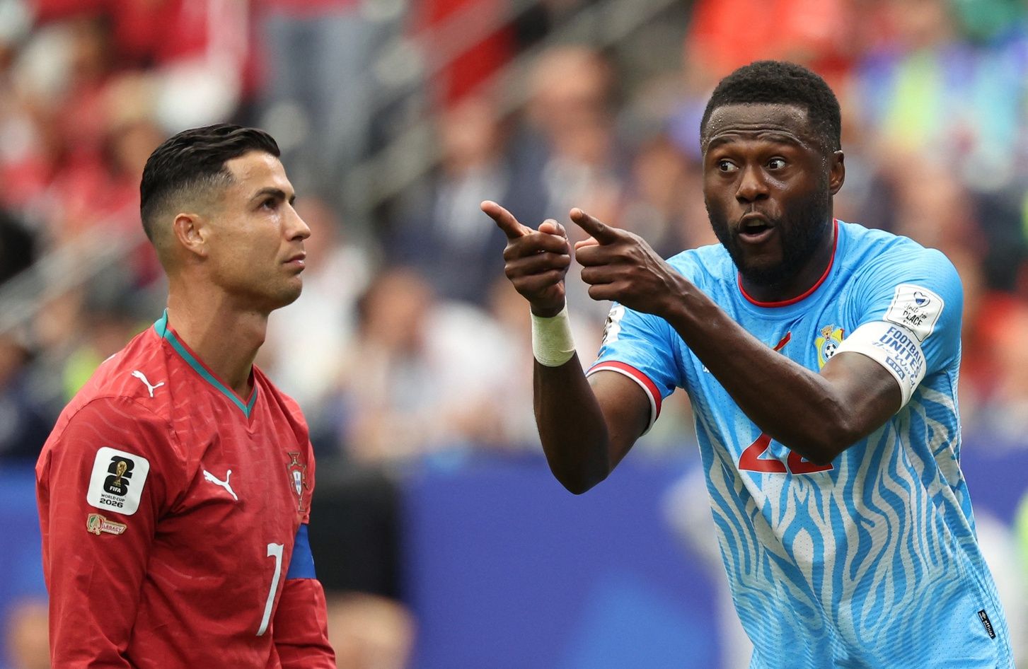 Portugal's Cristiano Ronaldo and DR Congo's Chancel Mbemba react.