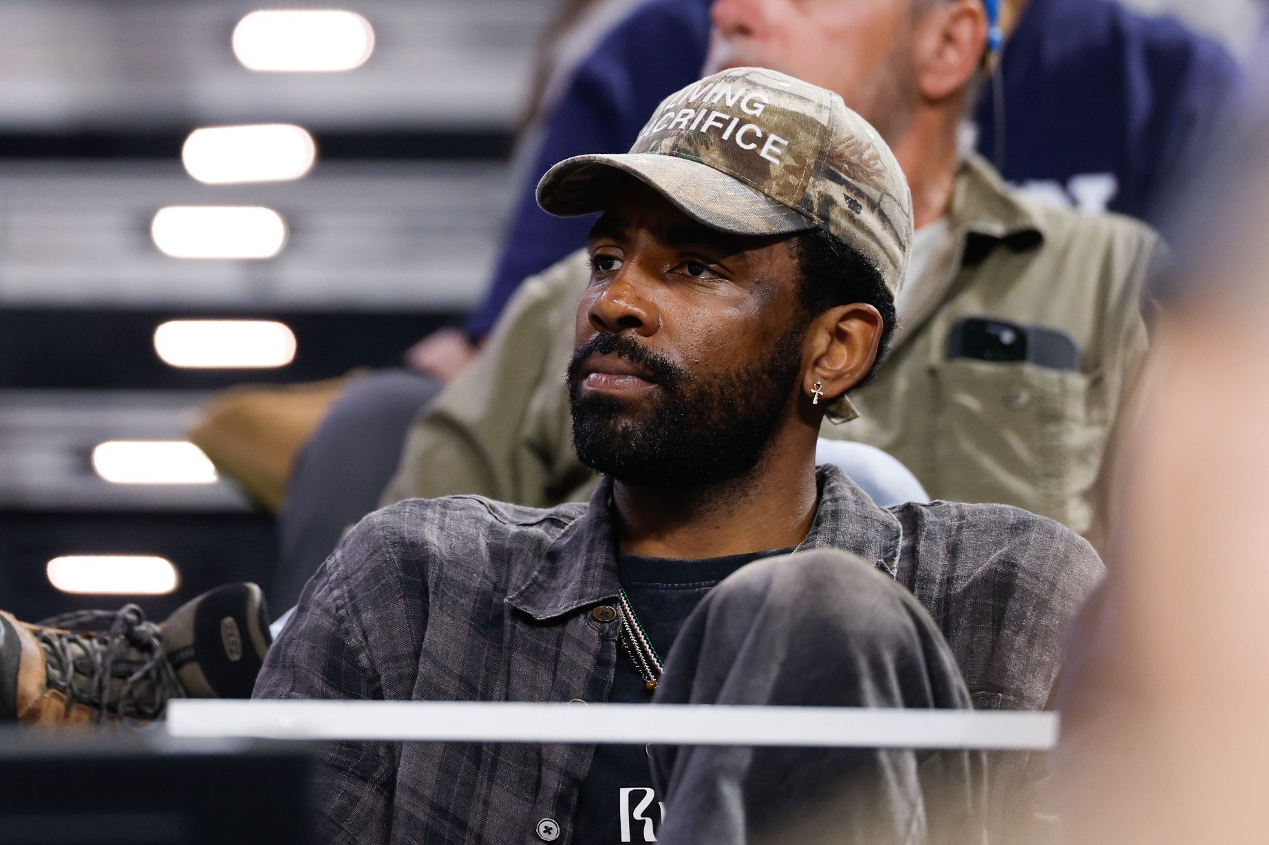 Dallas Mavericks guard Kyrie Irving looks on from the stands during the second half of the game between the UConn Huskies and Notre Dame Fighting Irish at Dickies Arena.