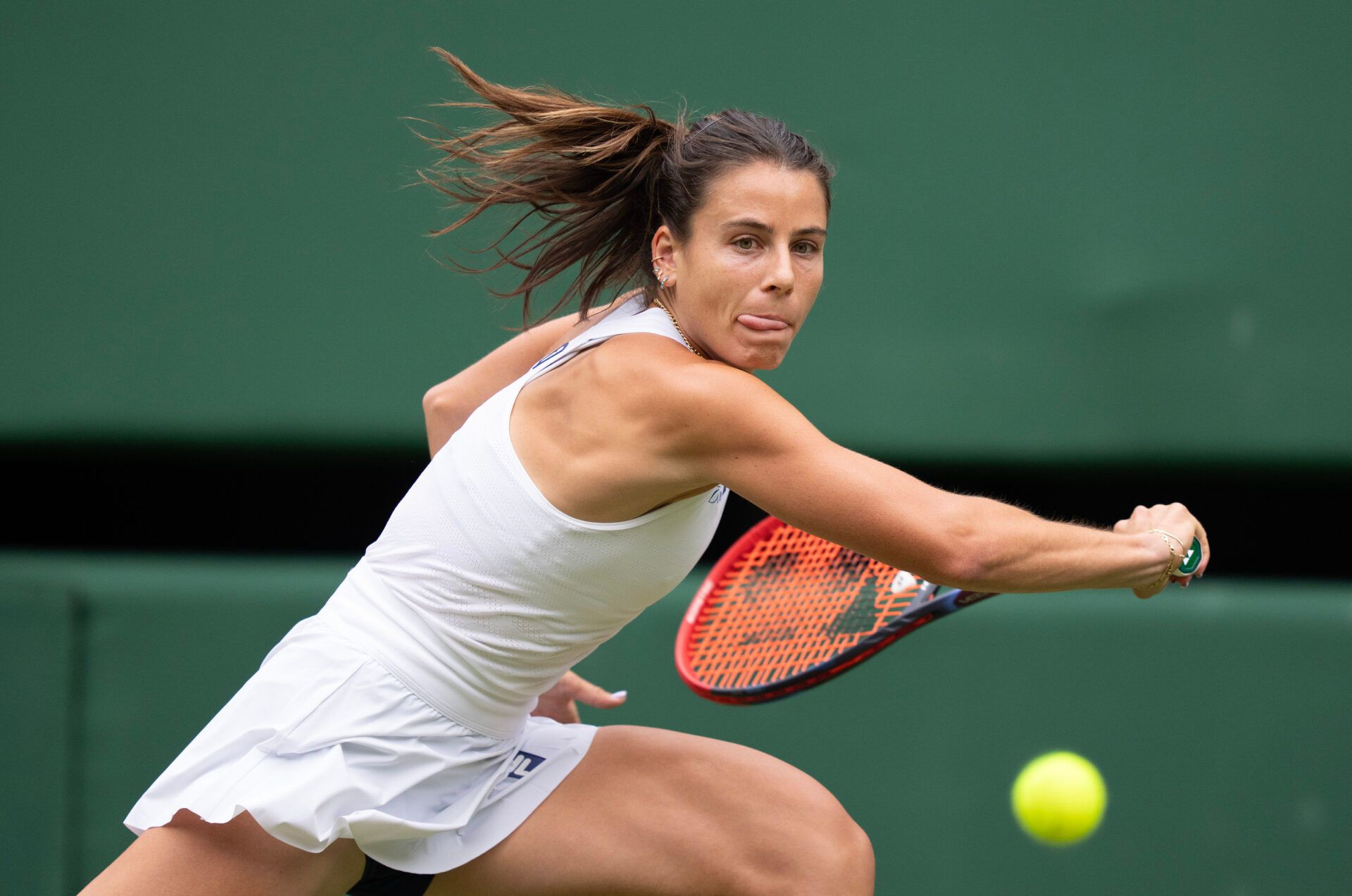 Emma Navarro of the United States returns a shot during her match against Barbora Krejcikova of the Czech Republic on day six at the All England Lawn Tennis and Croquet Club.