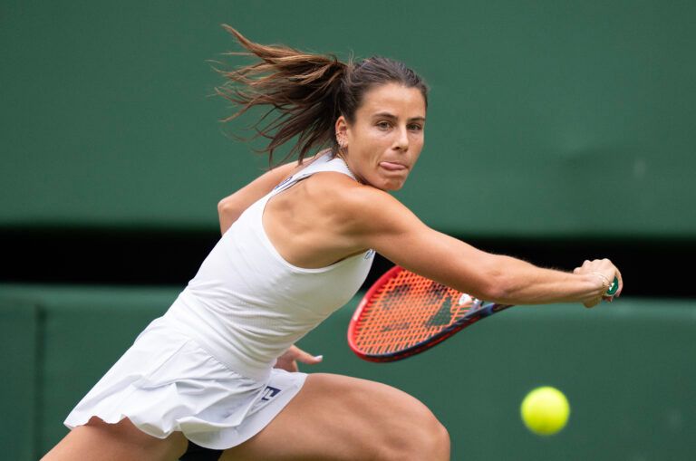 Emma Navarro of the United States returns a shot during her match against Barbora Krejcikova of the Czech Republic on day six at the All England Lawn Tennis and Croquet Club.