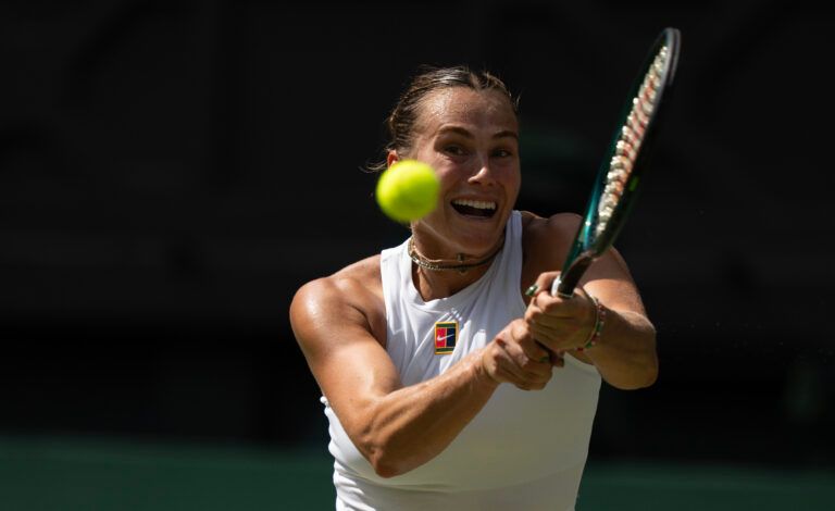 Aryna Sabalenka returns a shot during her match against Amanda Anisimova of the United States on day 11 at All England Lawn Tennis and Croquet Club.