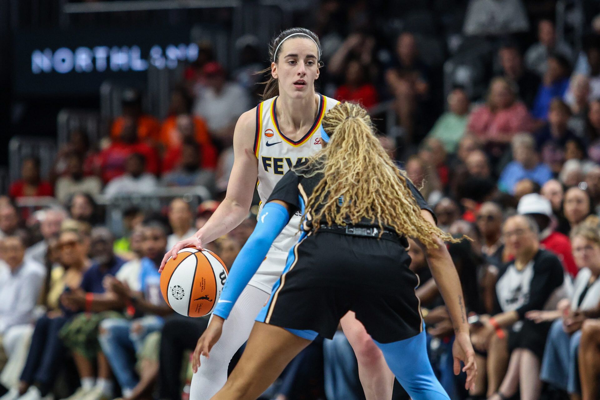 Indiana Fever guard Caitlin Clark (22) dribbles the ball against Atlanta Dream guard Jordin Canada (3) durignteh first quarter at State Farm Arena.