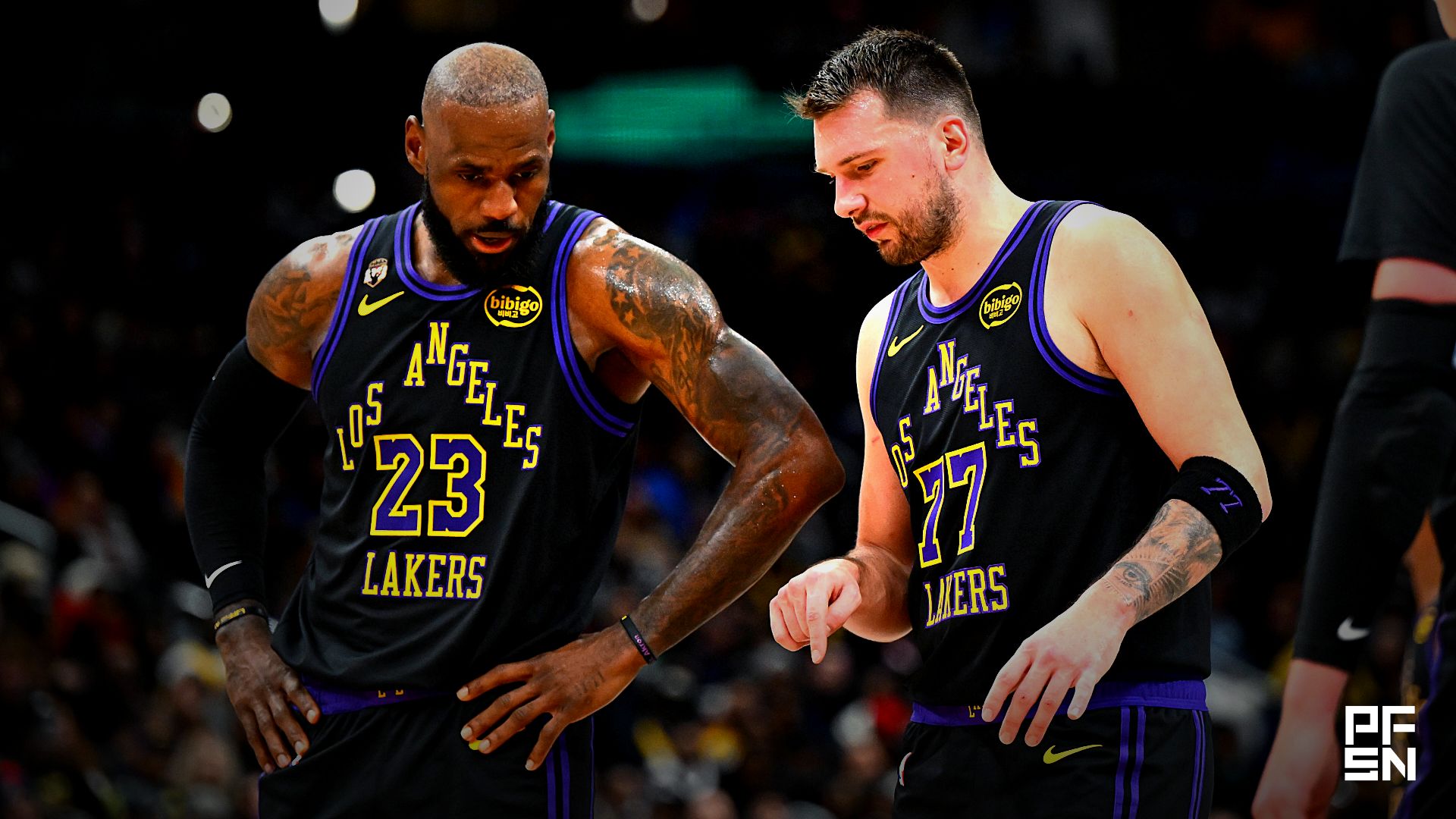Los Angeles Lakers forward/guard Luka Doncic (77) talks with Los Angeles Lakers forward LeBron James (23) against the Washington Wizards during the second half at Capital One Arena.