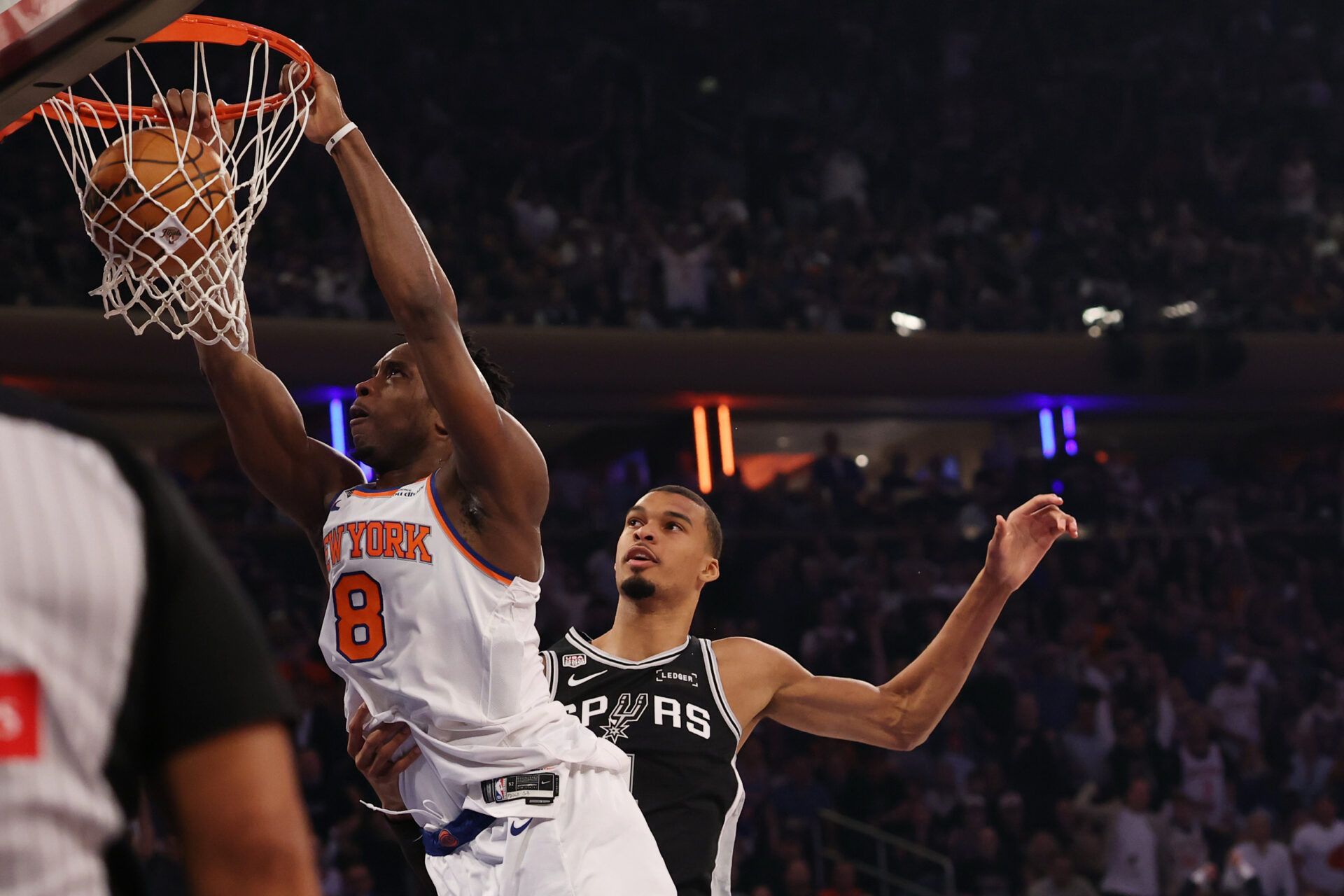 New York Knicks forward Og Anunoby (8) dunks the ball as San Antonio Spurs forward Victor Wembanyama (1) defends during game three of the 2026 NBA Finals at Madison Square Garden.