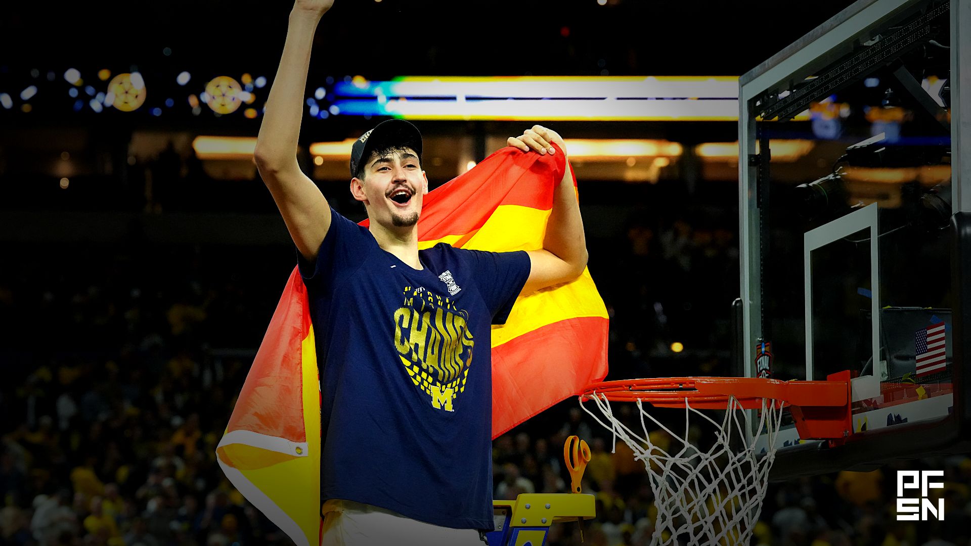 Michigan Wolverines center Aday Mara (15) celebrates after cutting down a piece of the net after defeating the Connecticut Huskies in the national championship of the Final Four of the men's 2026 NCAA Tournament at Lucas Oil Stadium.