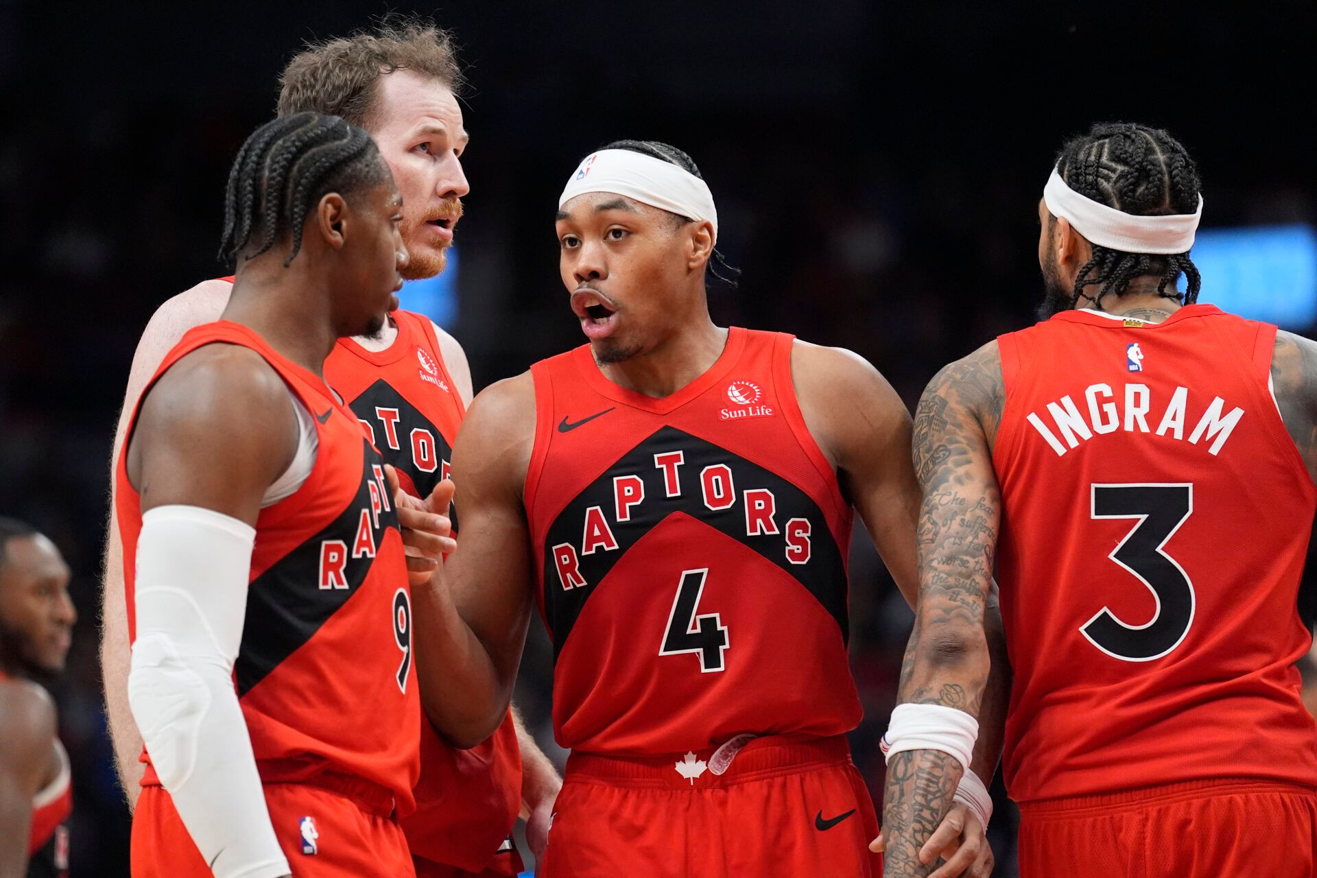 Toronto Raptors guard Scottie Barnes (4) talks to forward RJ Barrett (9) and center Jakob Poeltl (19) and forward Brandon Ingram (3) during a break in the action against the Detroit Pistons during the fourth quarter at Scotiabank Arena.