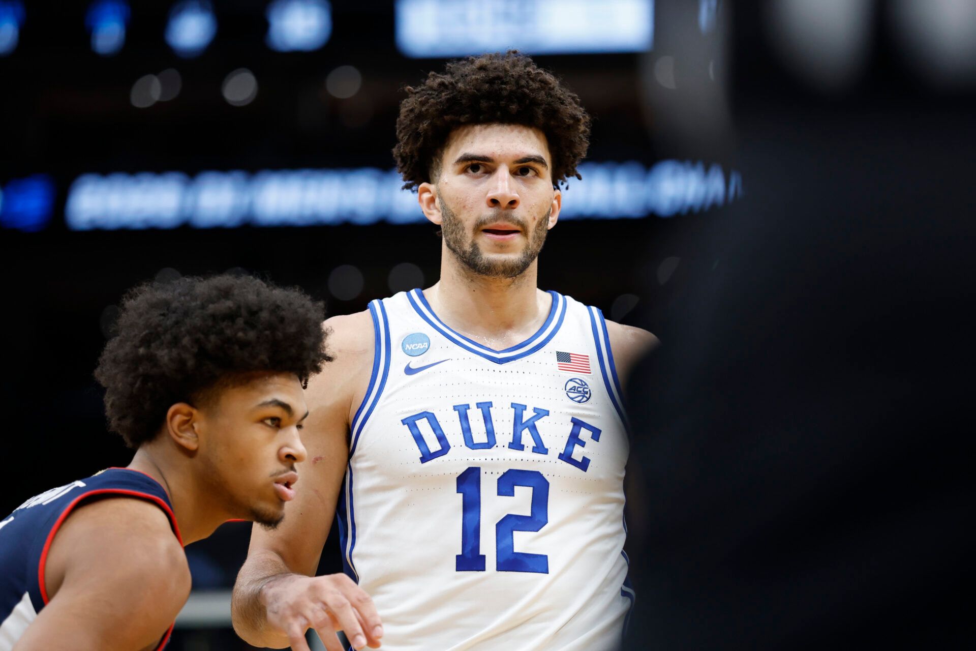 Duke Blue Devils forward Cameron Boozer (12) waits for the ball to be thrown into play as UConn Huskies forward Jaylin Stewart (3) defends in the first half during an Elite Eight game of the East Regional of the men's 2026 NCAA Tournament at Capital One Arena.