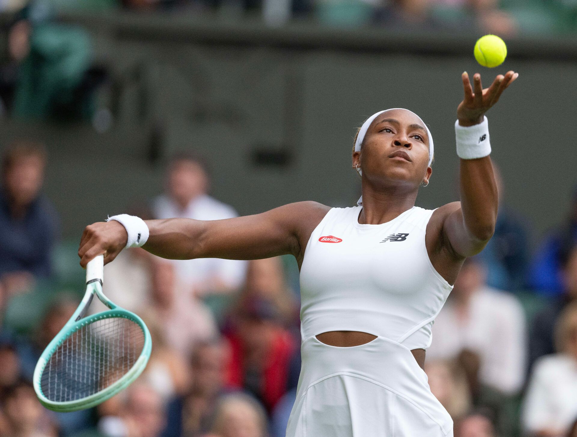 Coco Gauff of the United States tosses the ball to serve during her match against Caroline Dolehide of the United States (not shown) on day one of The Championships at All England Lawn Tennis and Croquet Club.