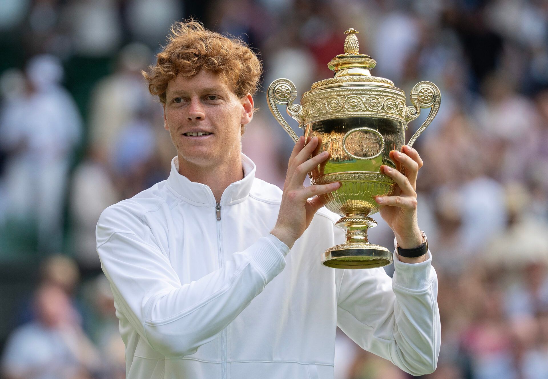 Jannik Sinner of Italy poses with the trophy after winning the menÕs singles final match against Carlos Alcaraz of Spain on day 14 at Wimbledon.