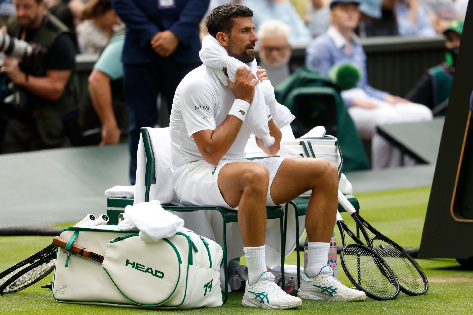 Novak Djokovic (SRB) holds an ice towel to his head during a changeover against Alex de Minaur (AUS)(not pictured) on day eight of The Championships Wimbledon 2025 at All England Lawn Tennis and Croquet Club.